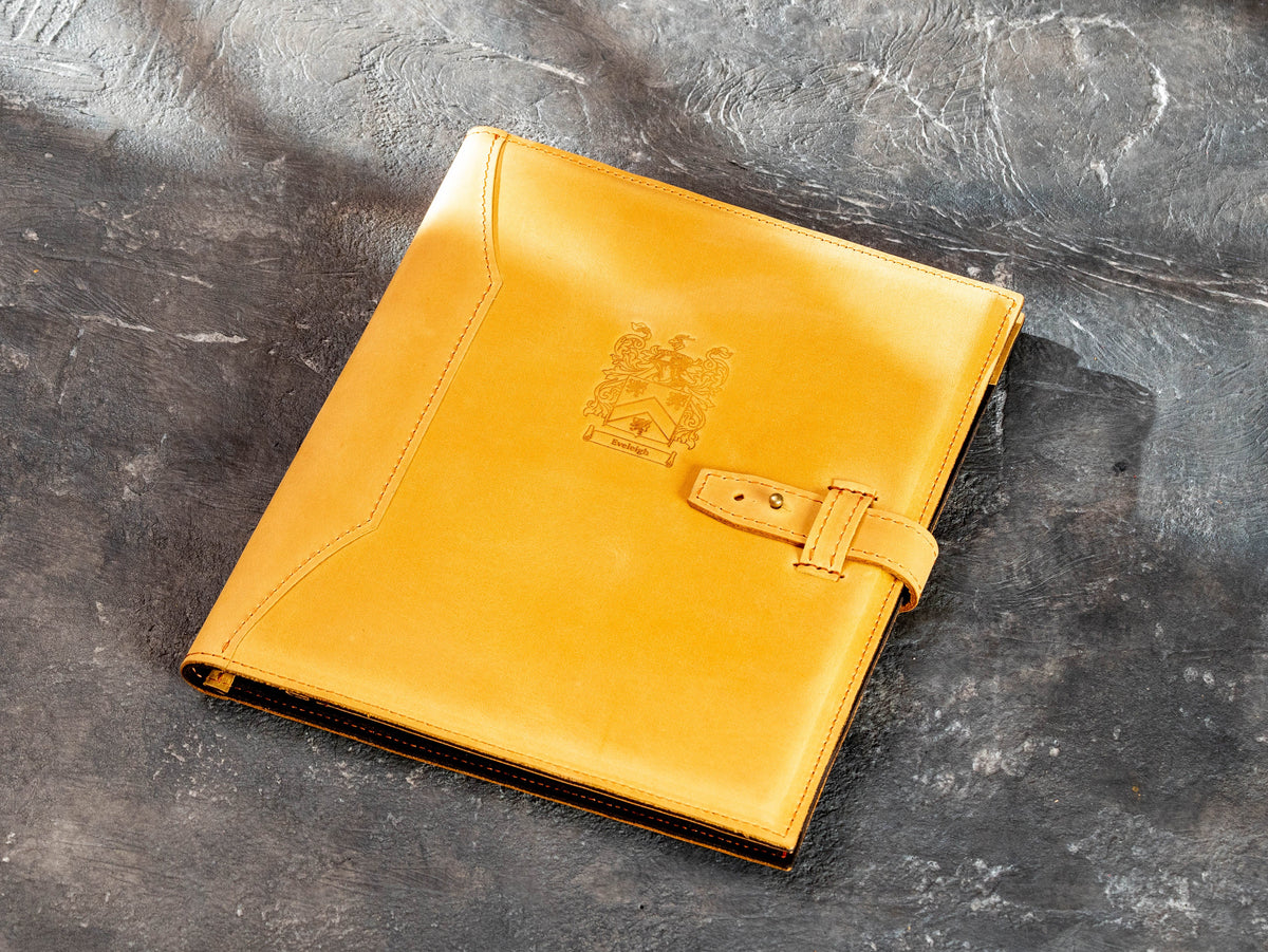 Front view of personalized leather portfolio with engraved custom crest