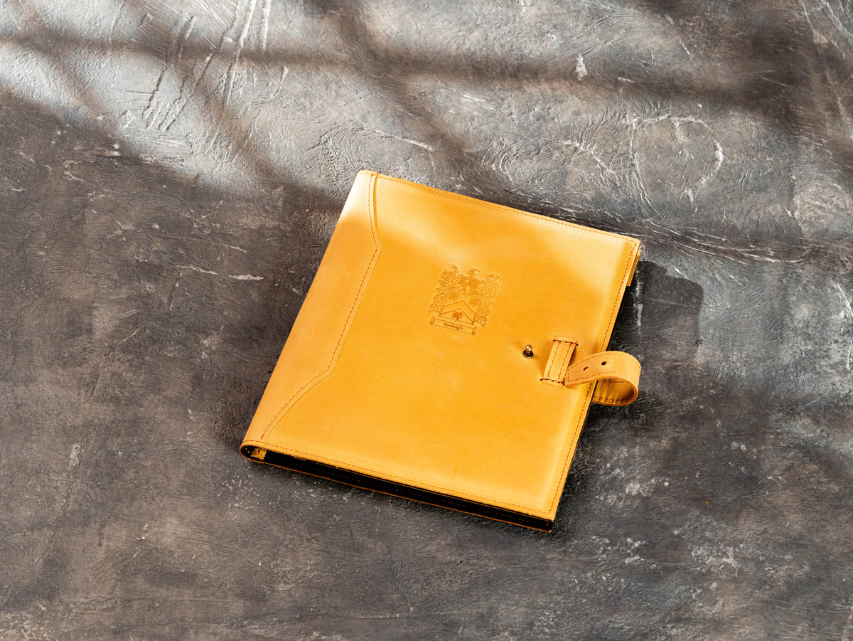 Open wheat leather portfolio with brown suede interior, pockets and pen holder