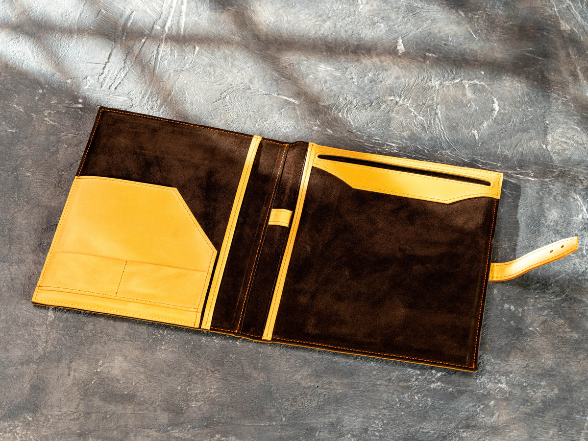 Open leather portfolio organized with Legal Pad, pen, business cards and documents