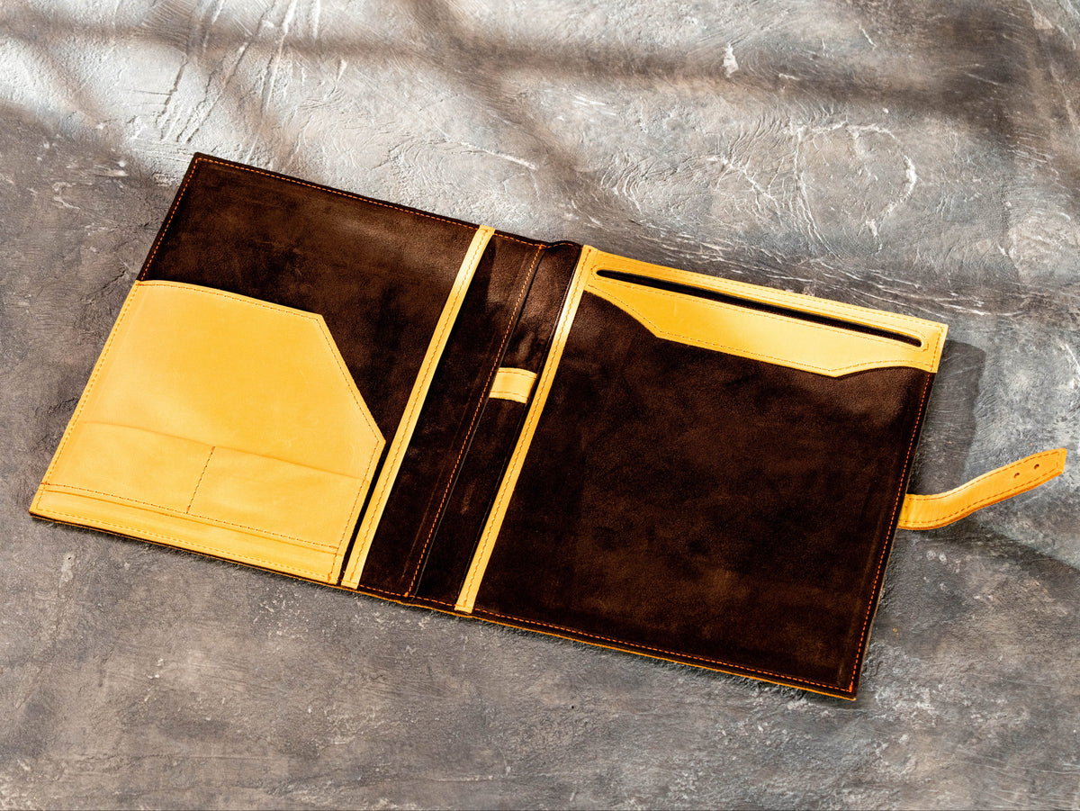 Open leather portfolio showing brown suede interior and large legal pad compartment