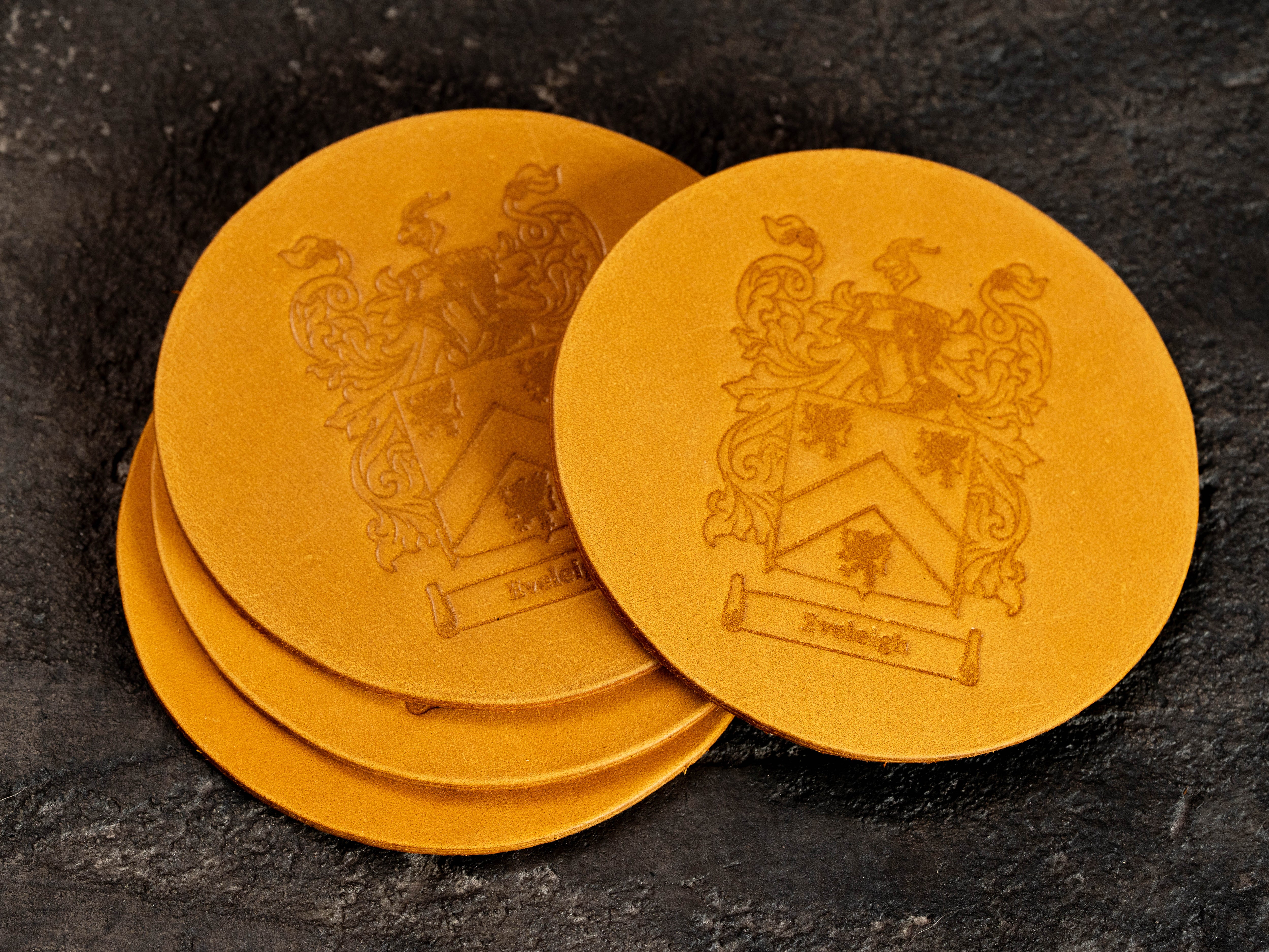 Personalized wheat yellow leather coasters with custom family crest and name embossing, made from thick 4 mm leather.