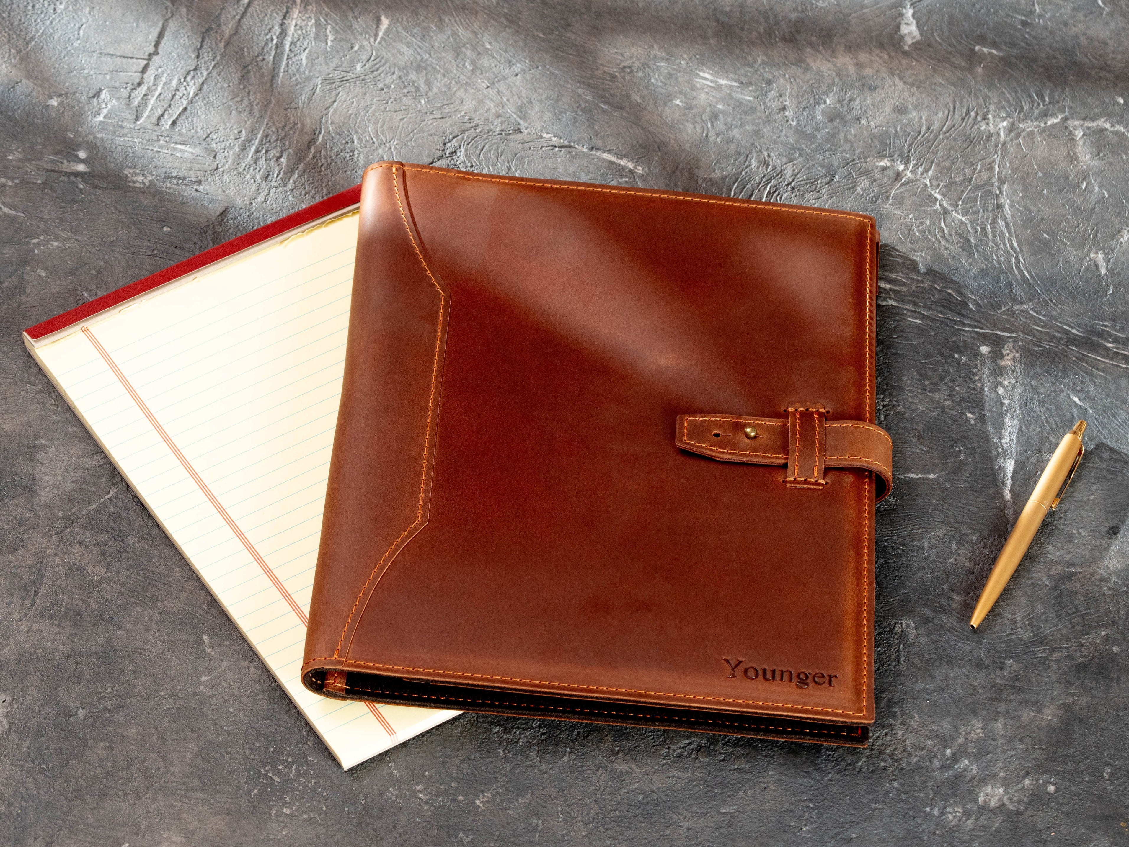 Personalized copper leather legal pad portfolio with name embossing, shown with 8.5 × 11.75 legal pad and pen.