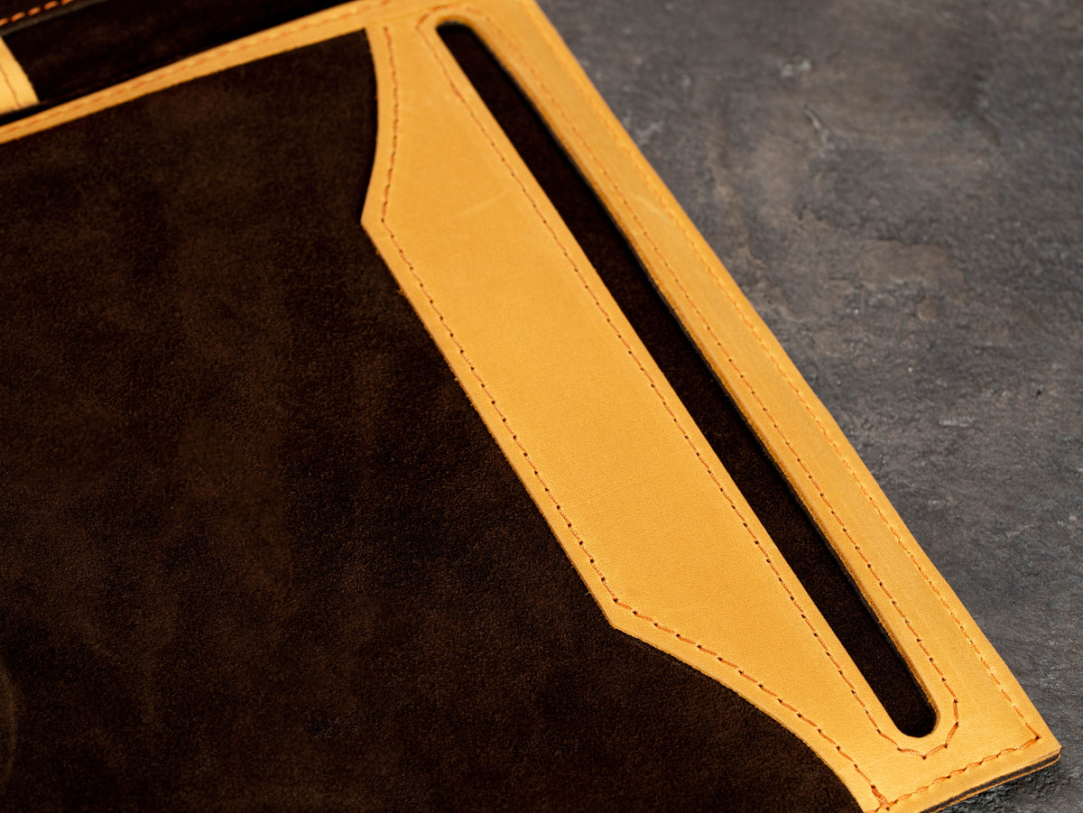 Detailed view of document pocket inside wheat leather portfolio with brown suede lining