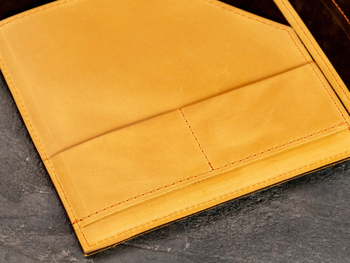 Close-up of interior card pockets and document organizer in wheat leather portfolio