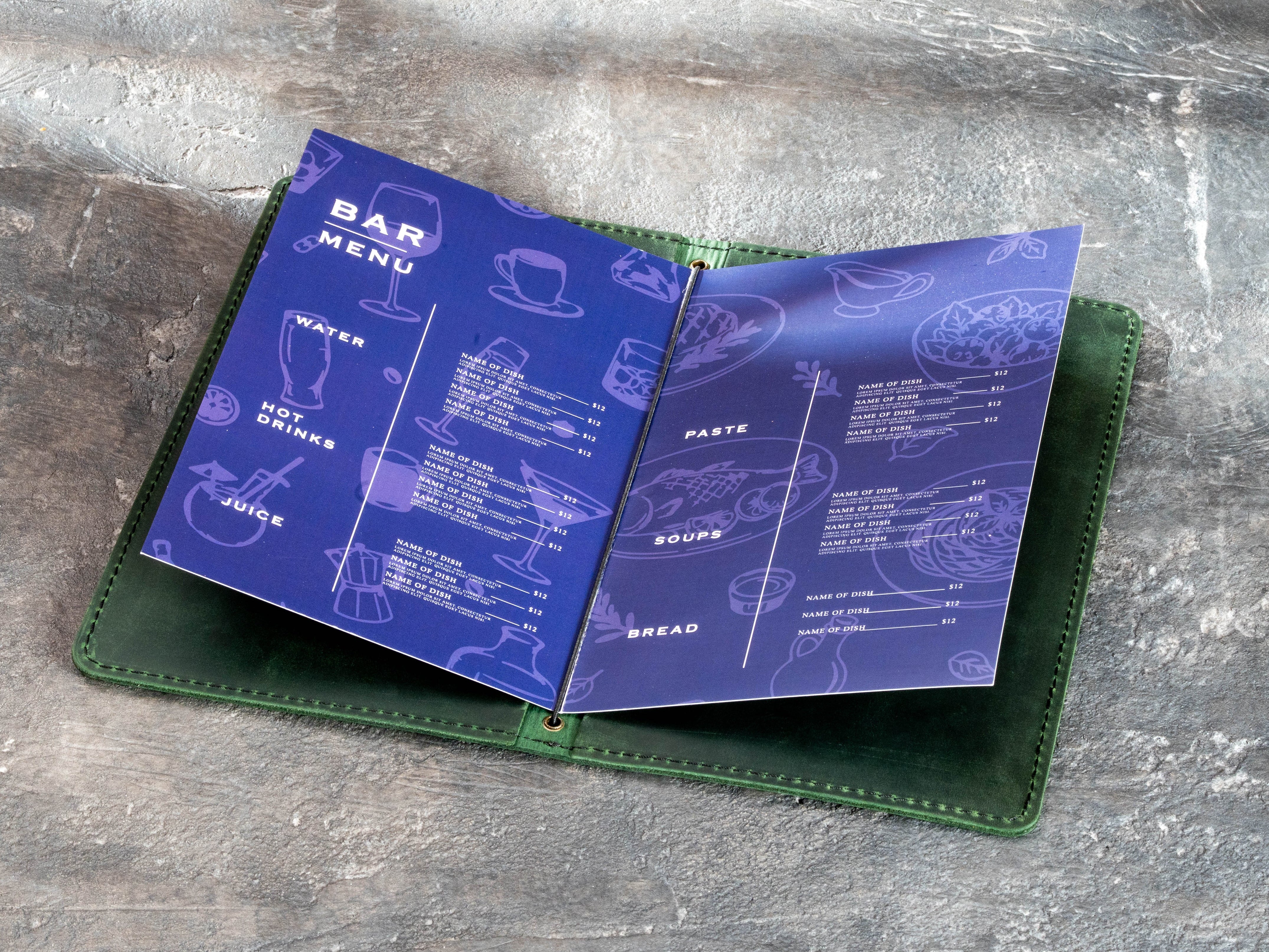 Green leather bar menu cover with printed cocktail and drink menu secured by elastic cord.