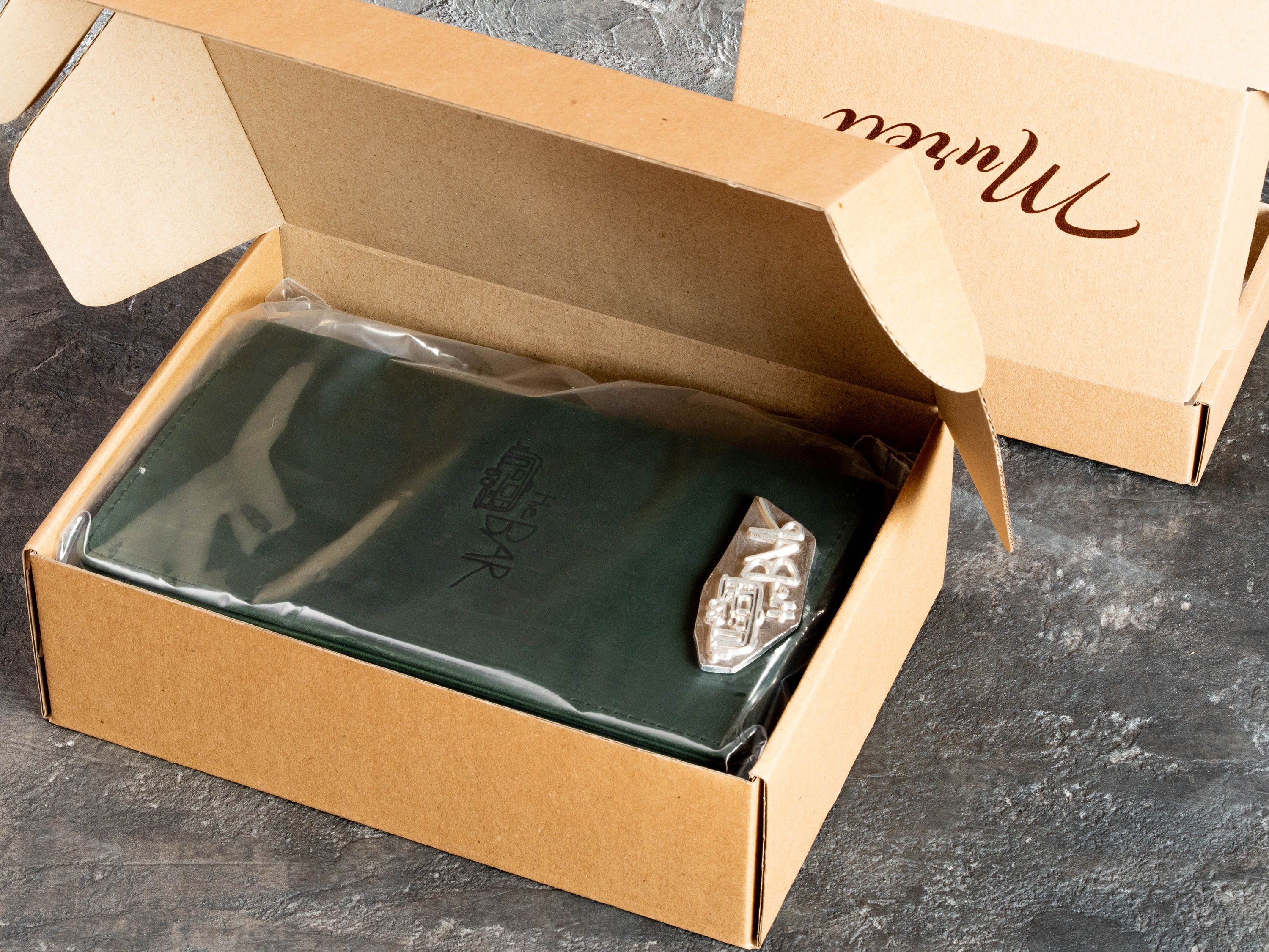 Custom leather bar menu covers packed before shipment as part of a completed client order.