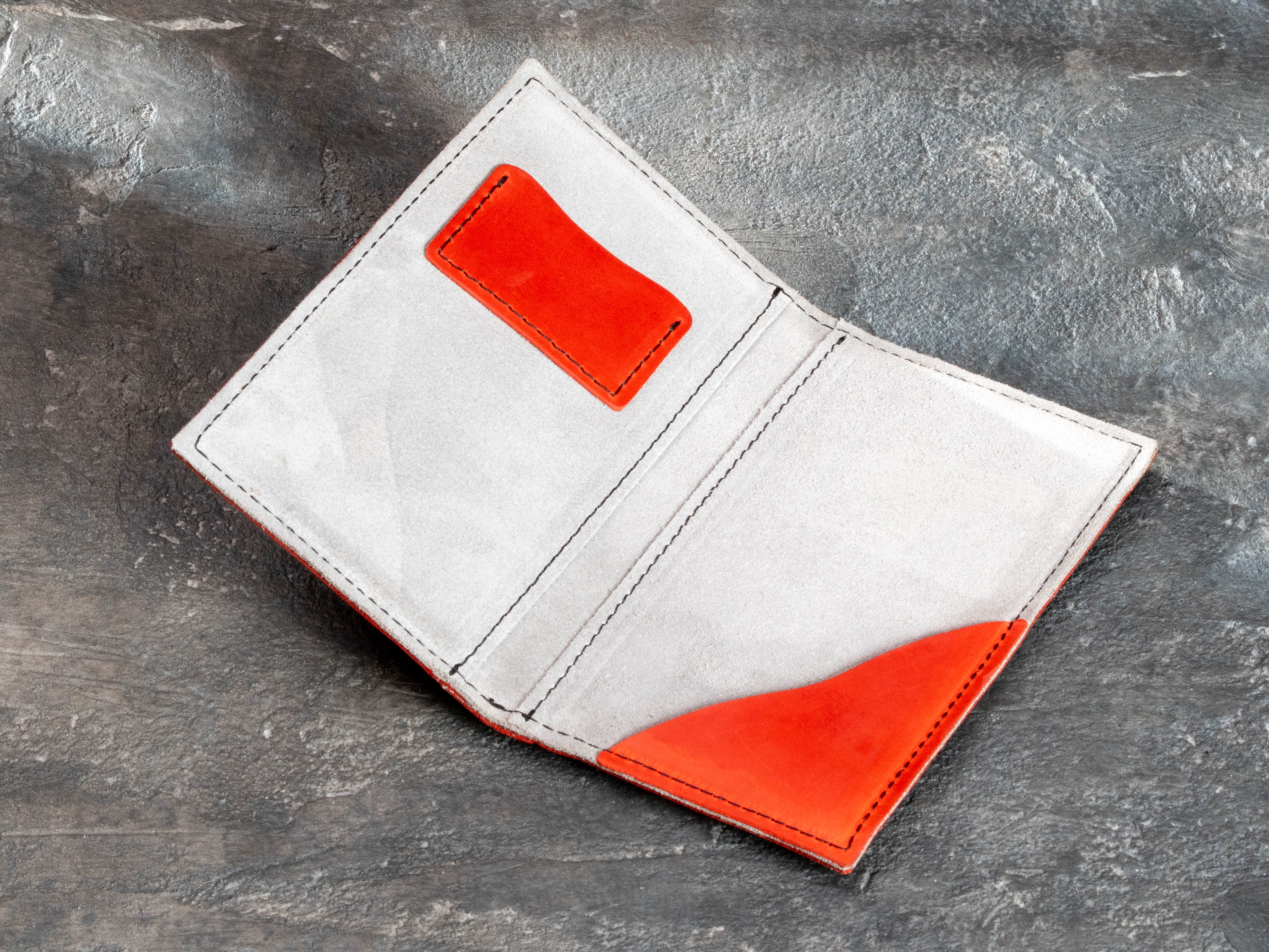 Red leather bill holder with dedicated card pocket and large payment pocket for cash or receipt.