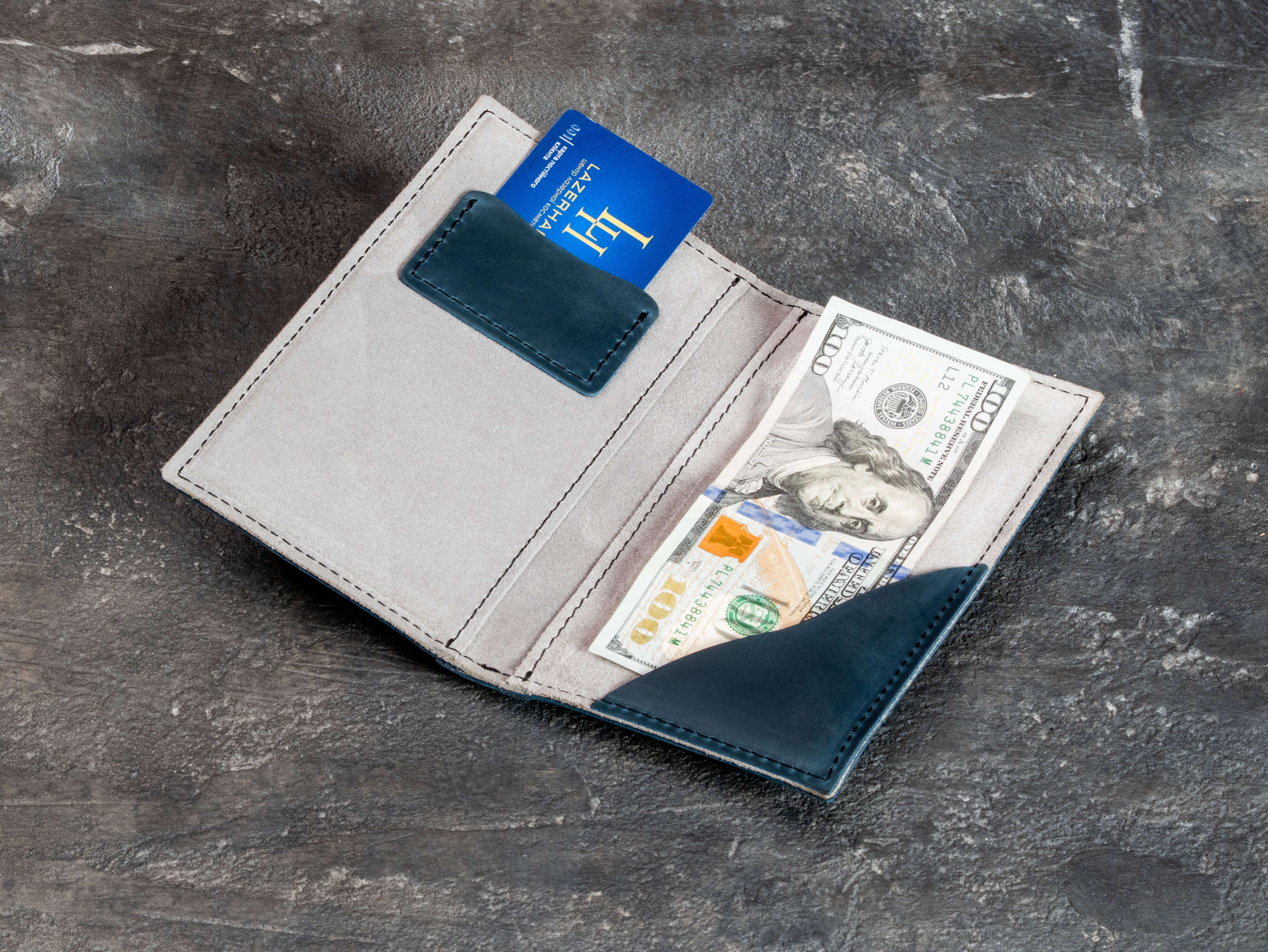 Custom blue leather restaurant payment folder with Casa Gabriela logo, stitched edges, and card pocket detail.