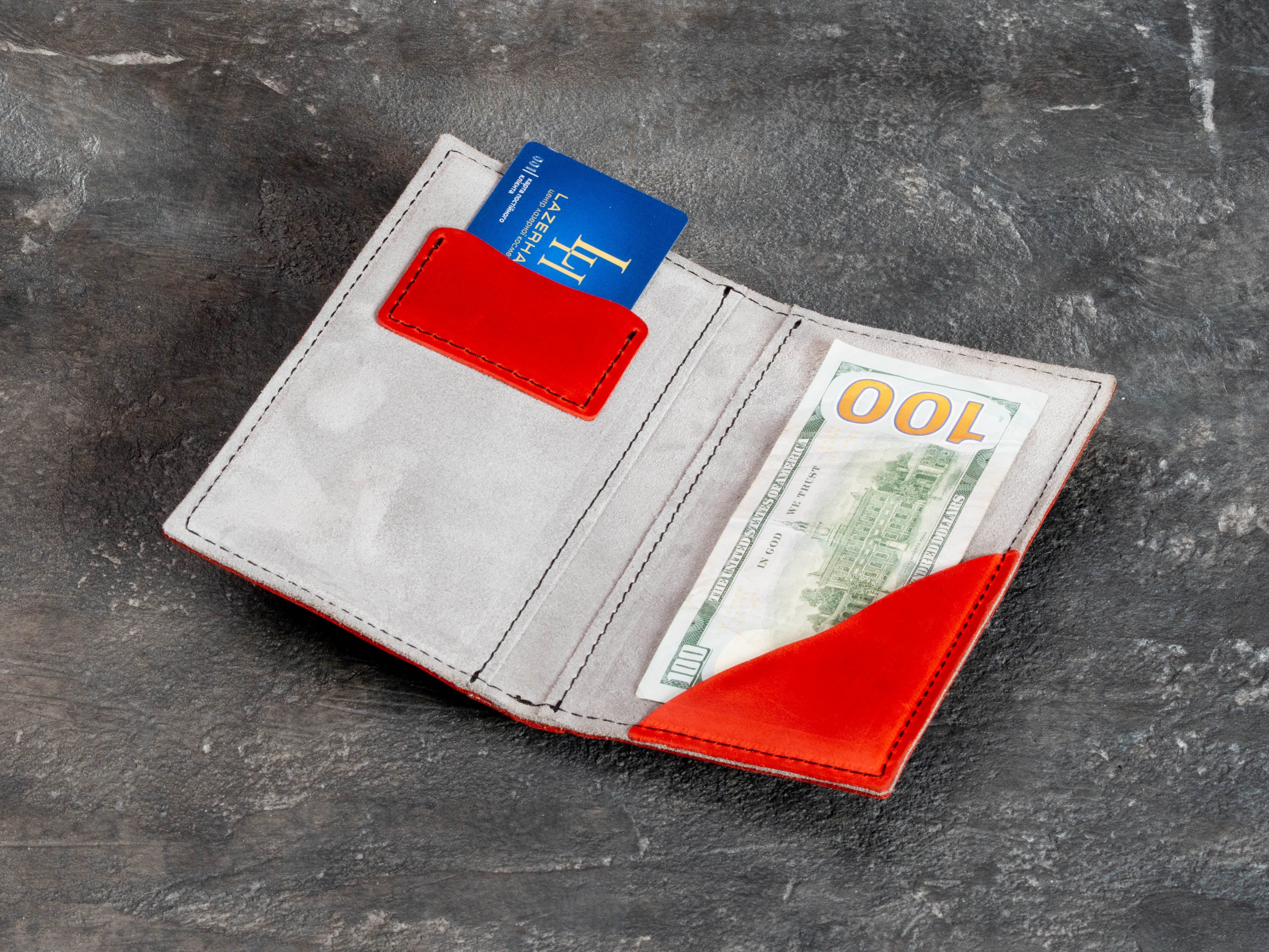 Light suede interior of red leather restaurant receipt presenter with card pocket and large cash or receipt pocket.