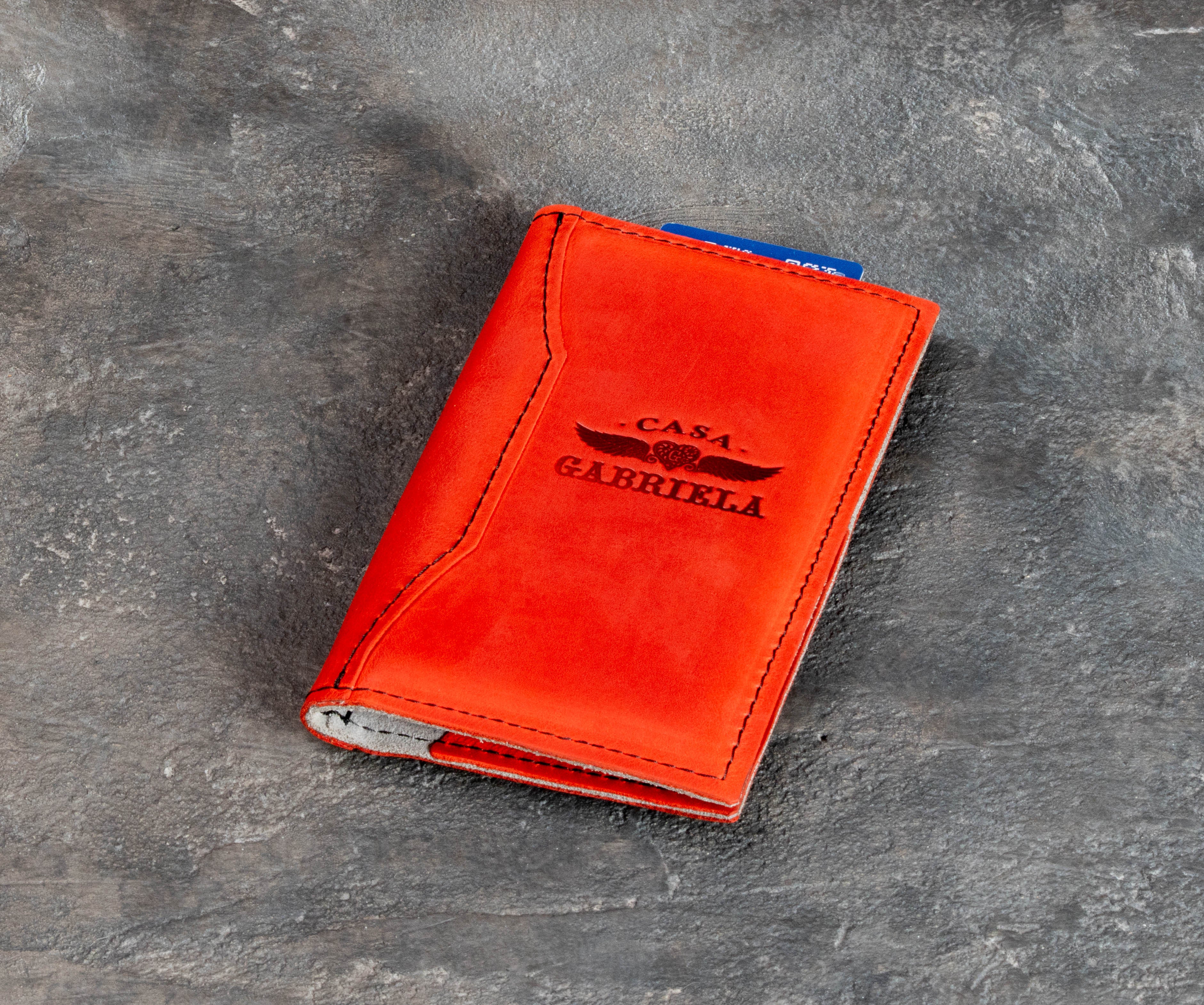 Red leather bill holder with dedicated card pocket and large payment pocket for cash or receipt.