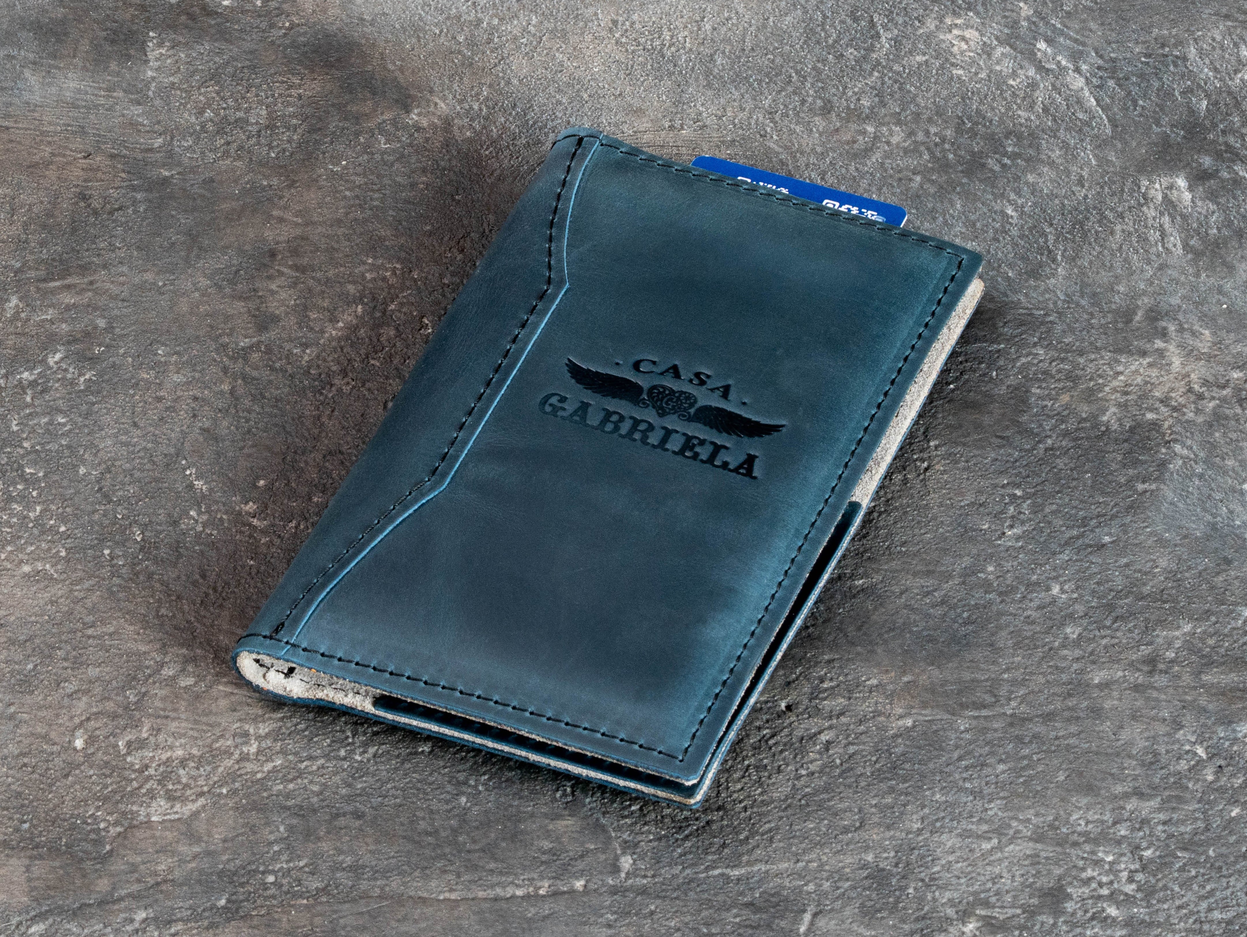 Blue deep teal leather guest check presenter with light suede interior, card pocket, and large cash or receipt pocket.