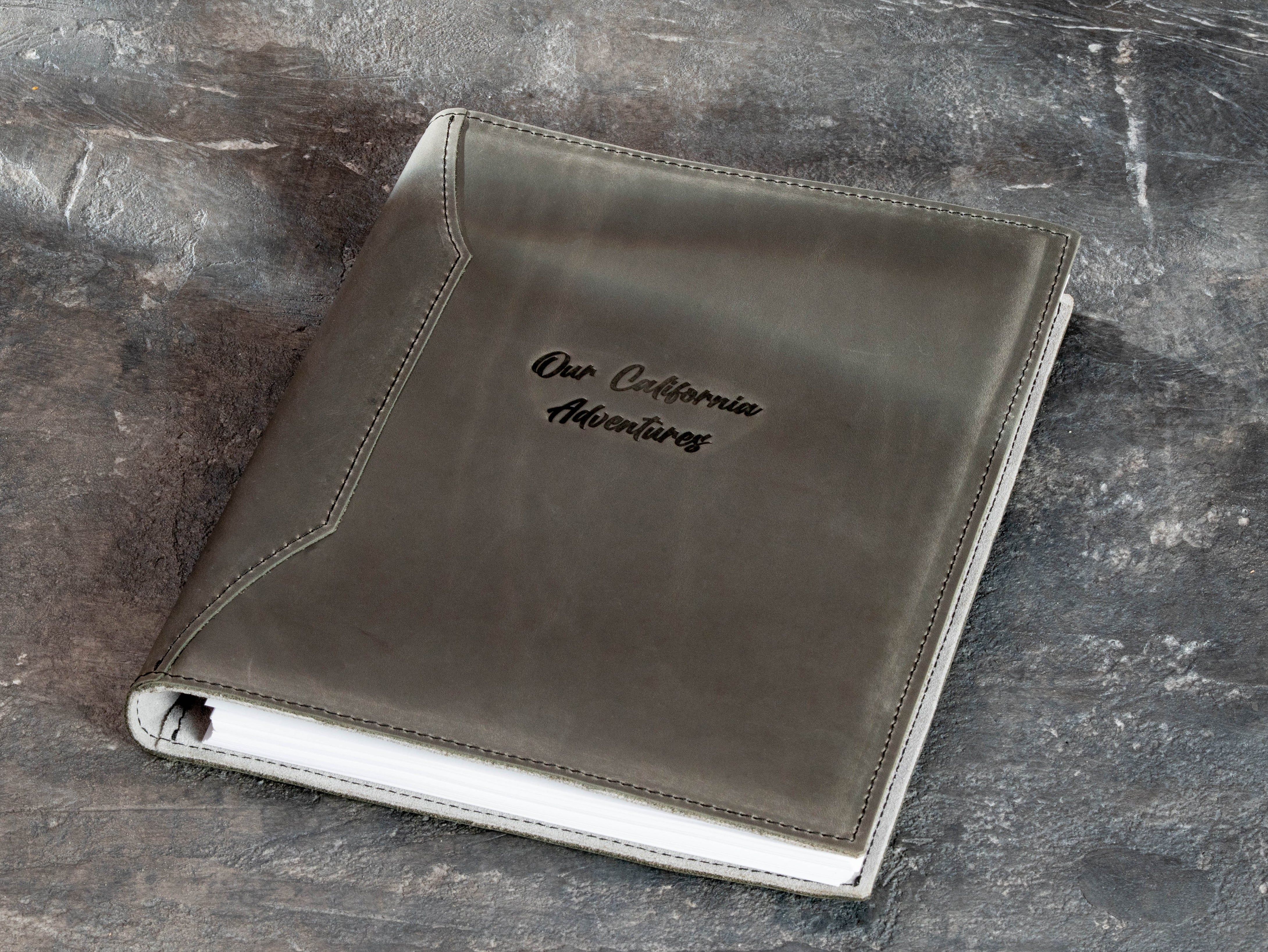 Personalized leather memory binder created for a family archive with custom embossed title.