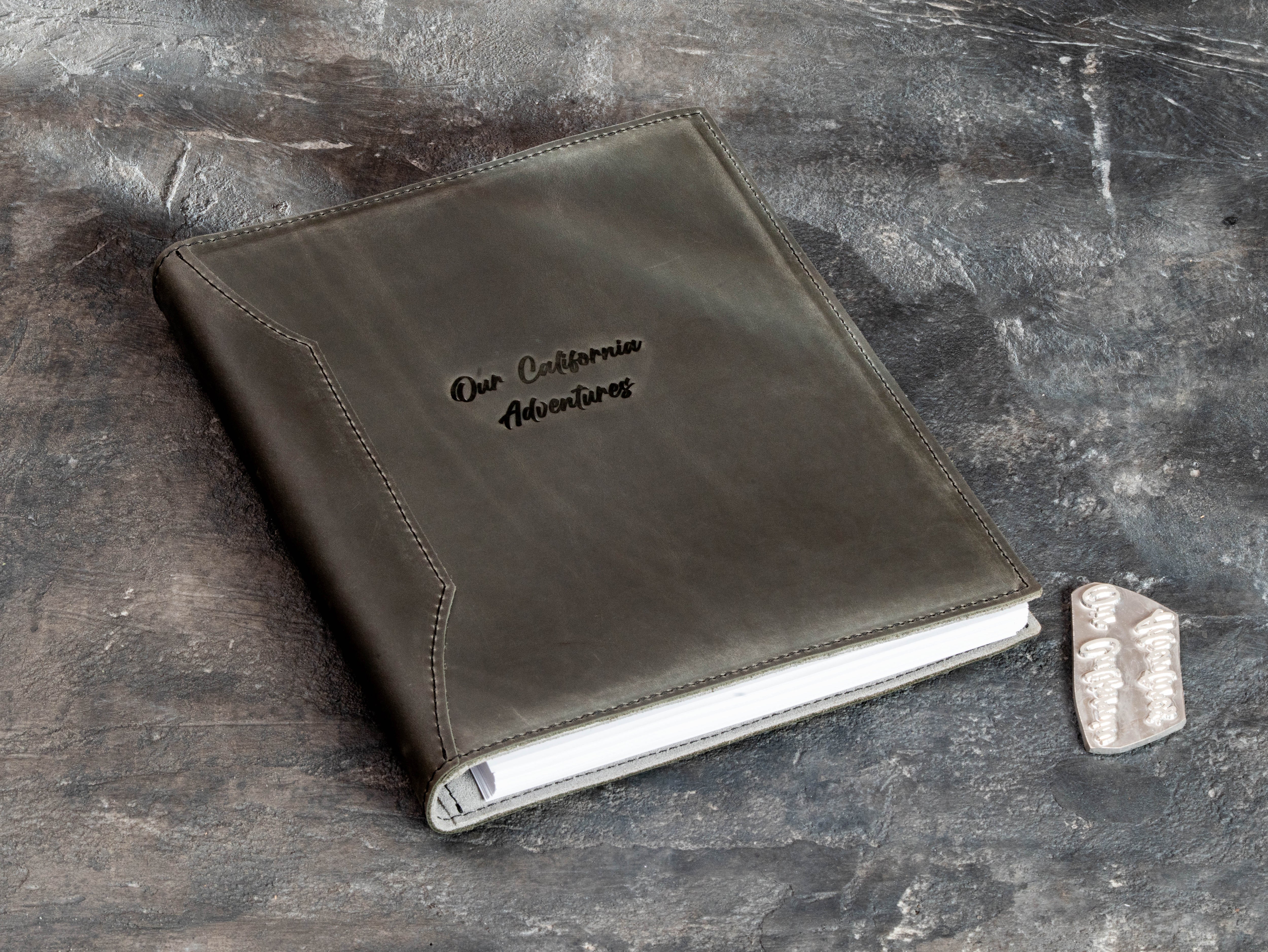 Custom leather memory book with personalized embossing and matching metal die reserved for the client’s repeat orders.