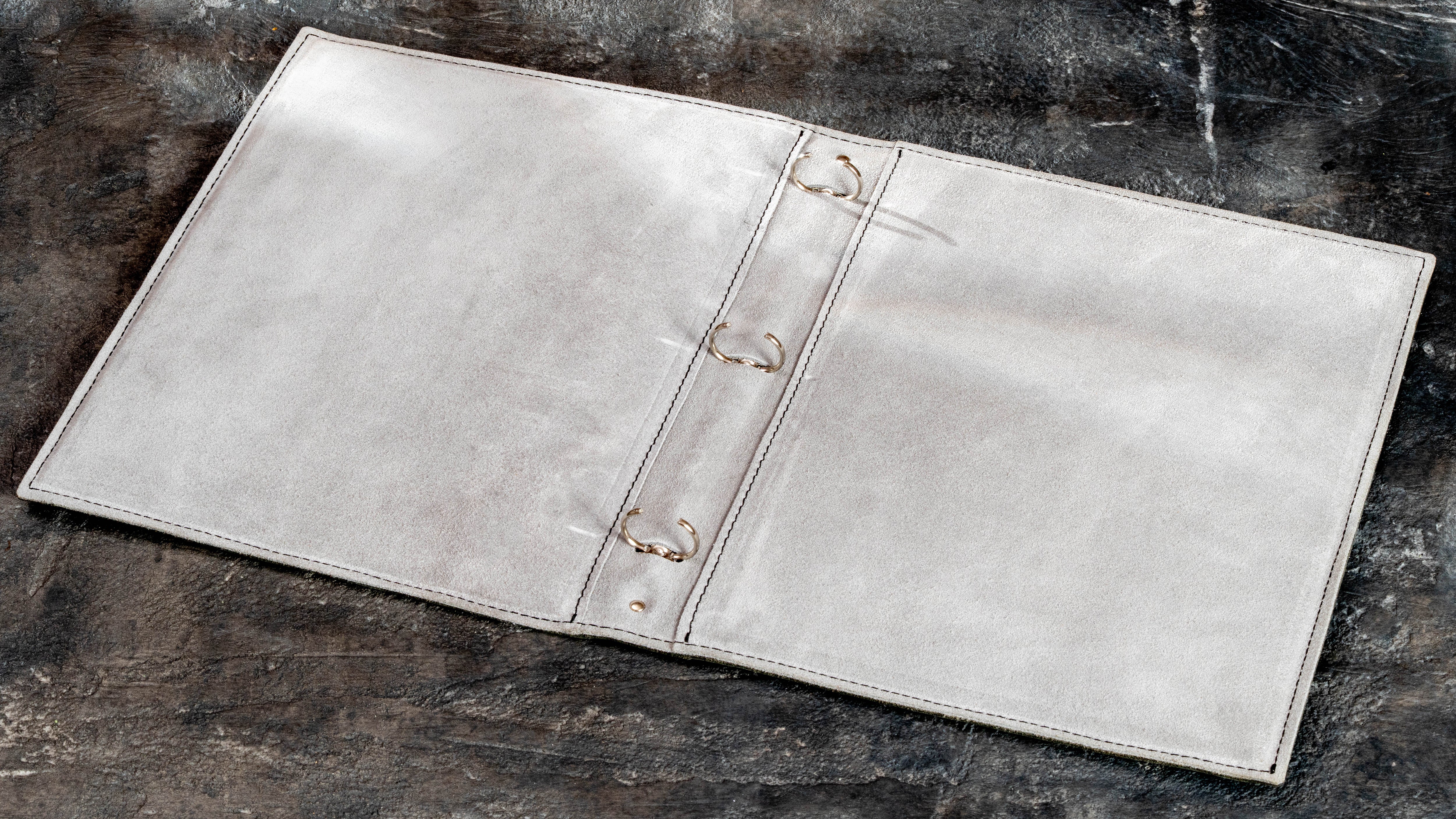 Suede interior of 3-ring family memory binder designed for plastic page protectors, photos, paper, and small flat keepsakes.