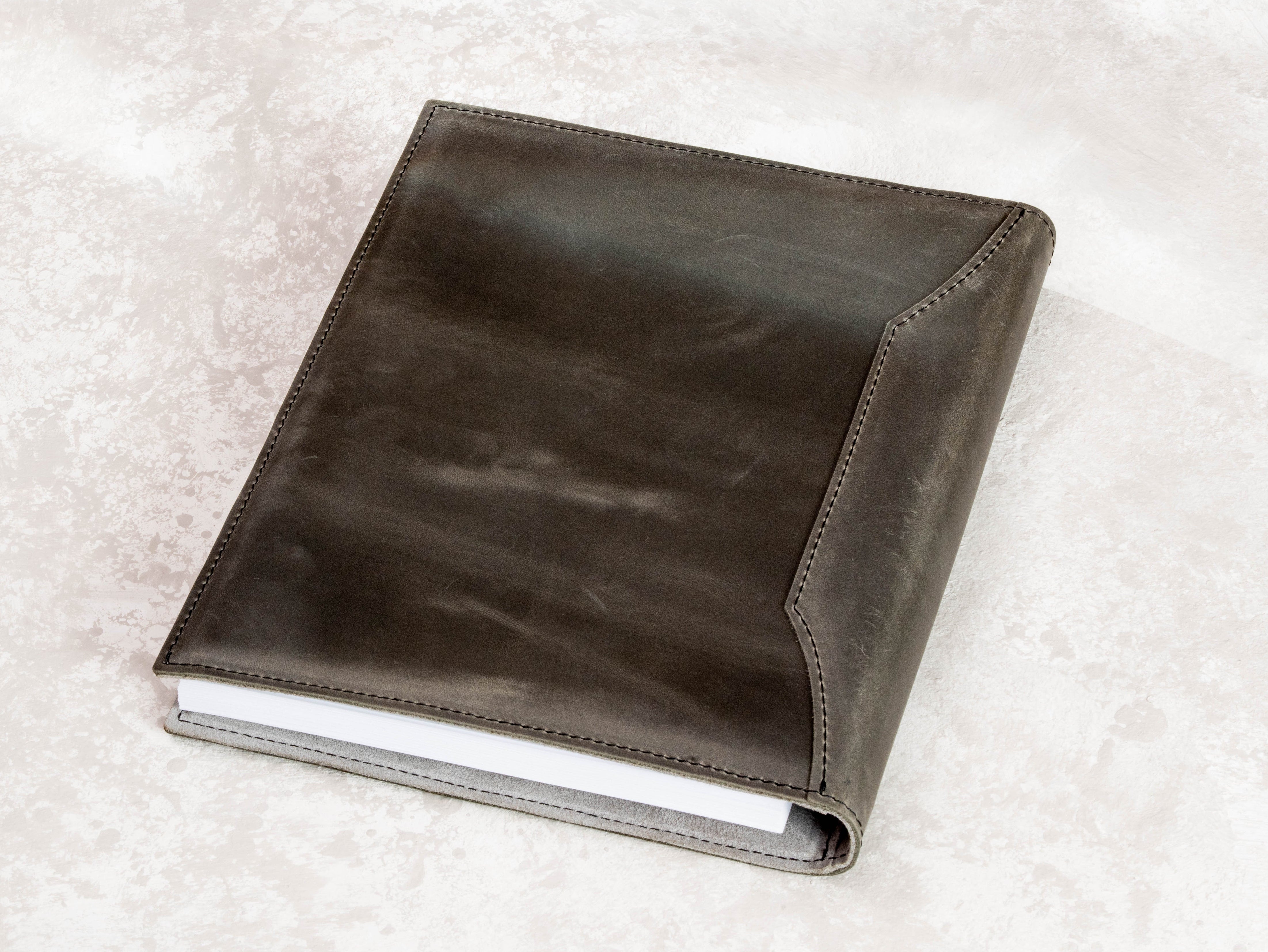 Leather family heirloom binder with stitched cover and space for photos, letters, documents, and keepsakes.