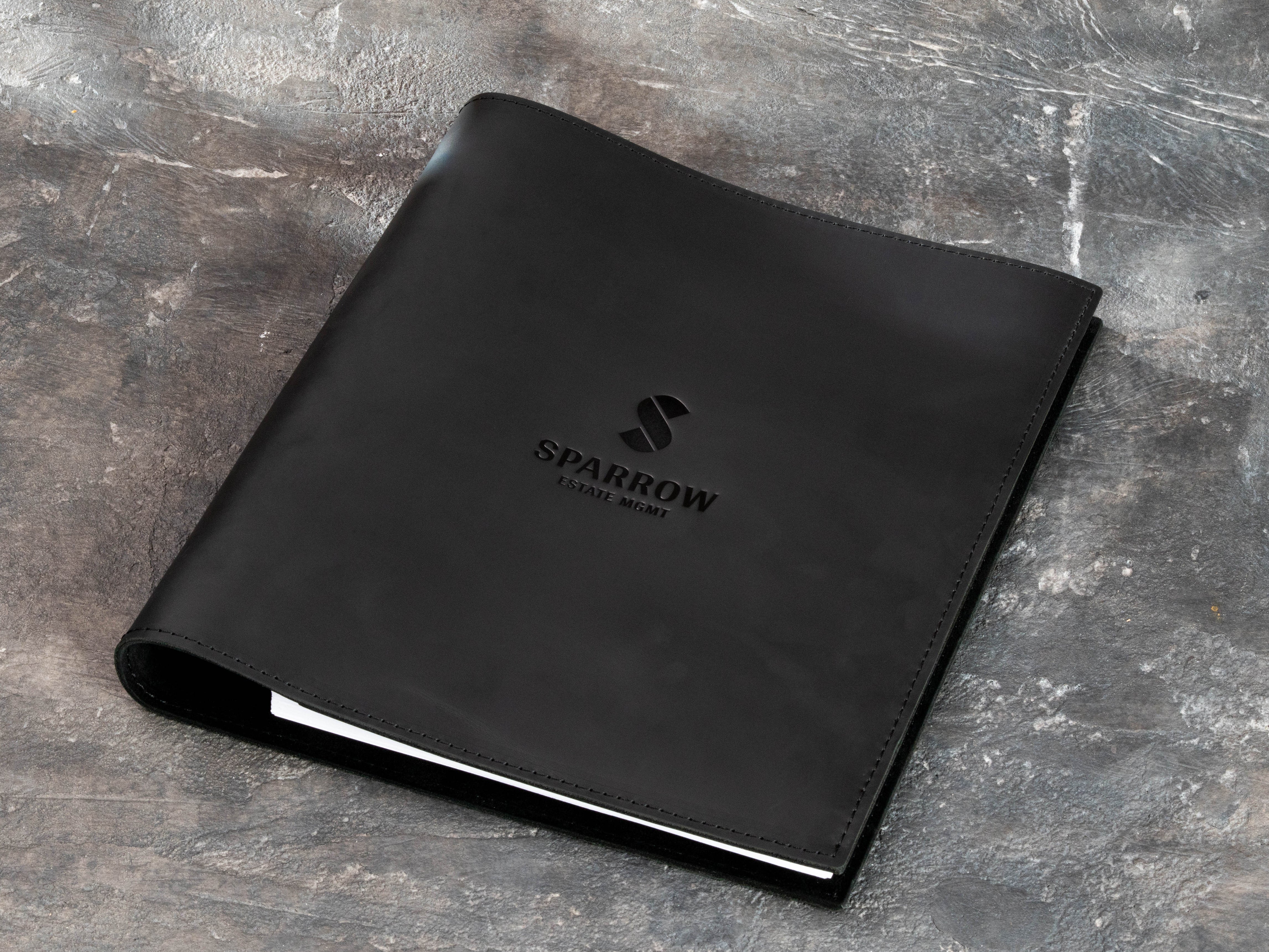 Black leather portfolio binder with flexible construction and slim profile for everyday carry
