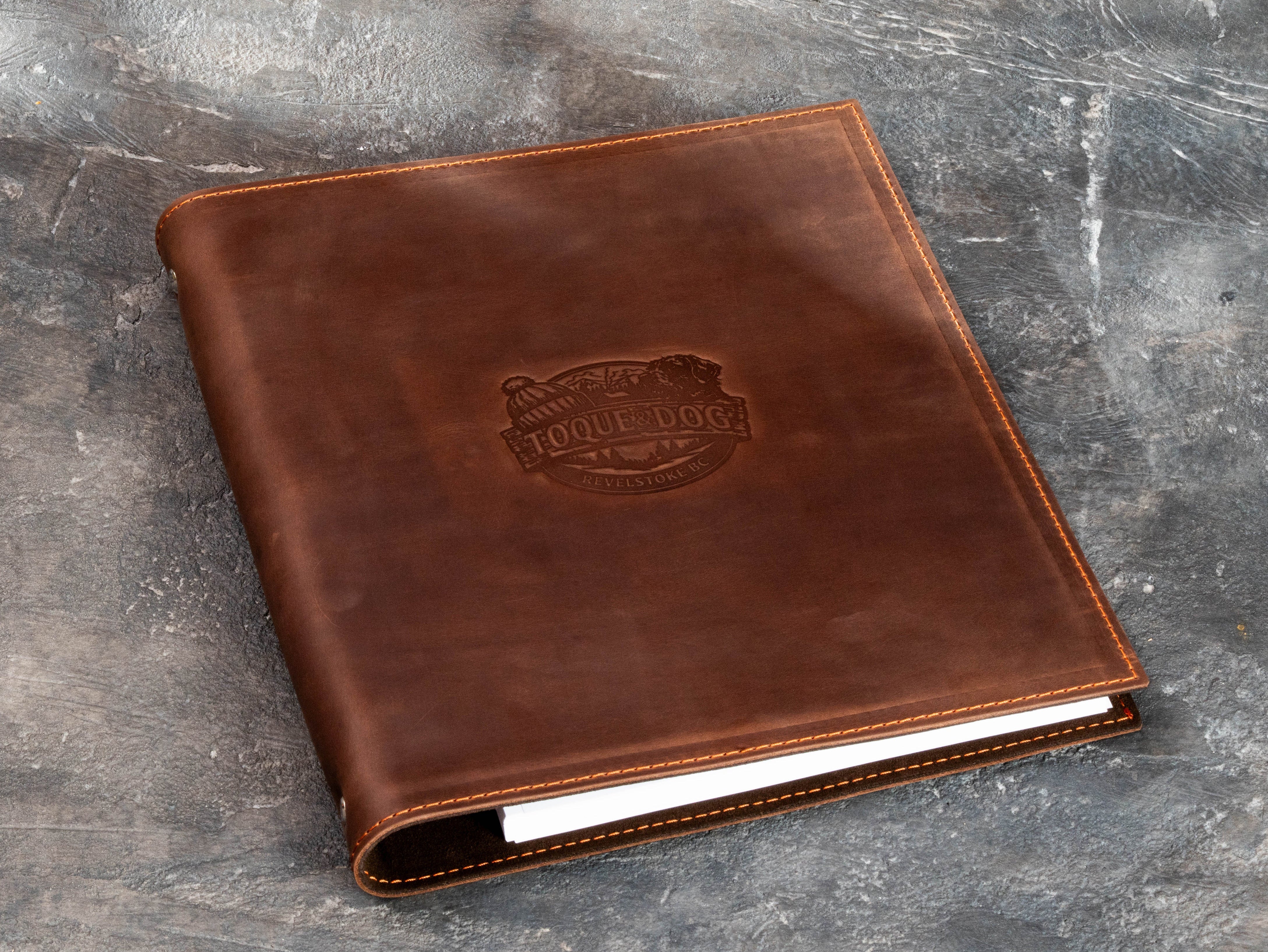 Warm brown leather guest information binder with custom outdoor logo and matching embossing die.