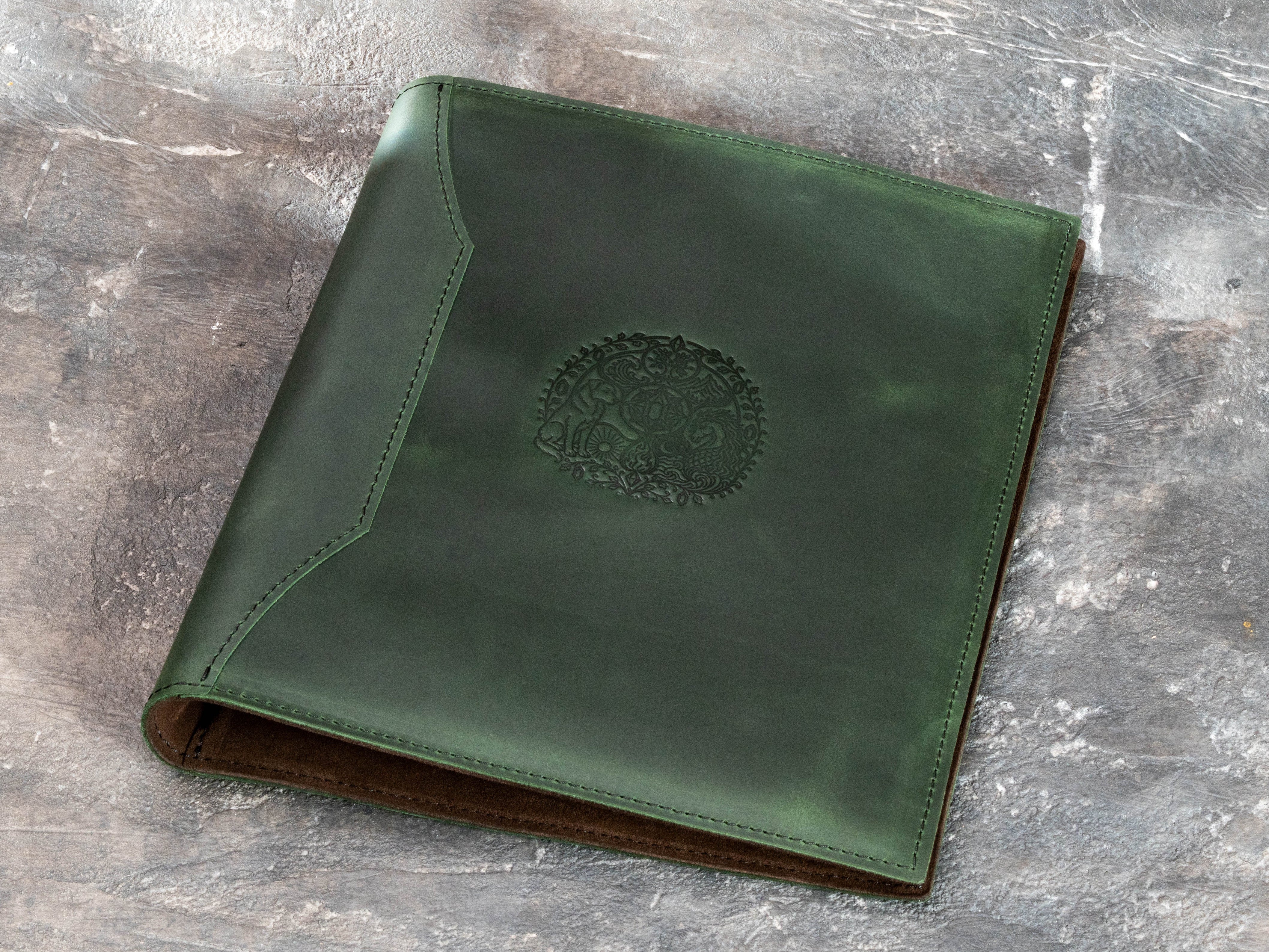Green leather memory binder with detailed fairy-tale inspired embossed artwork on the front cover
