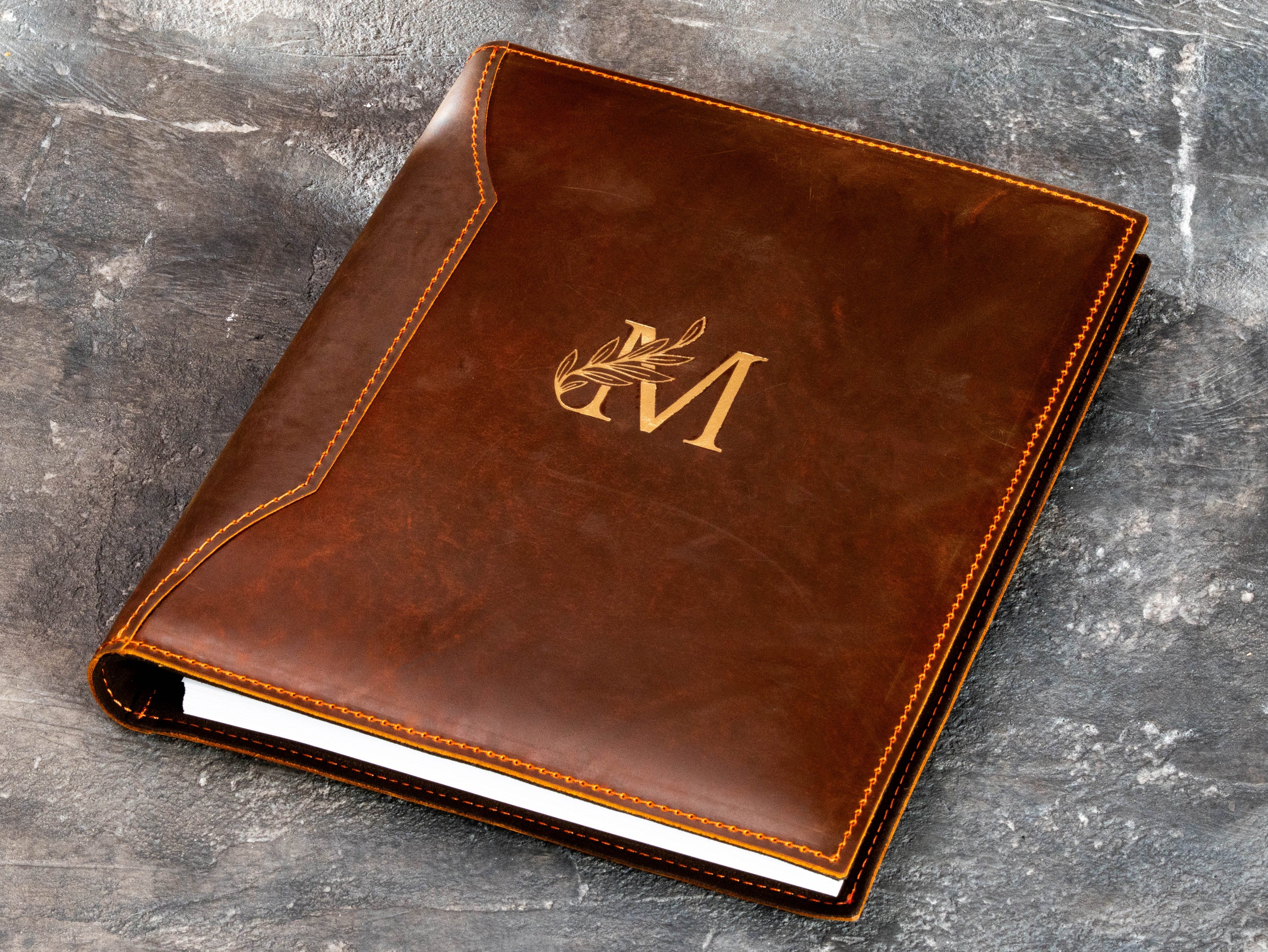 Personalized chestnut leather binder with gold monogram and decorative leather stitching