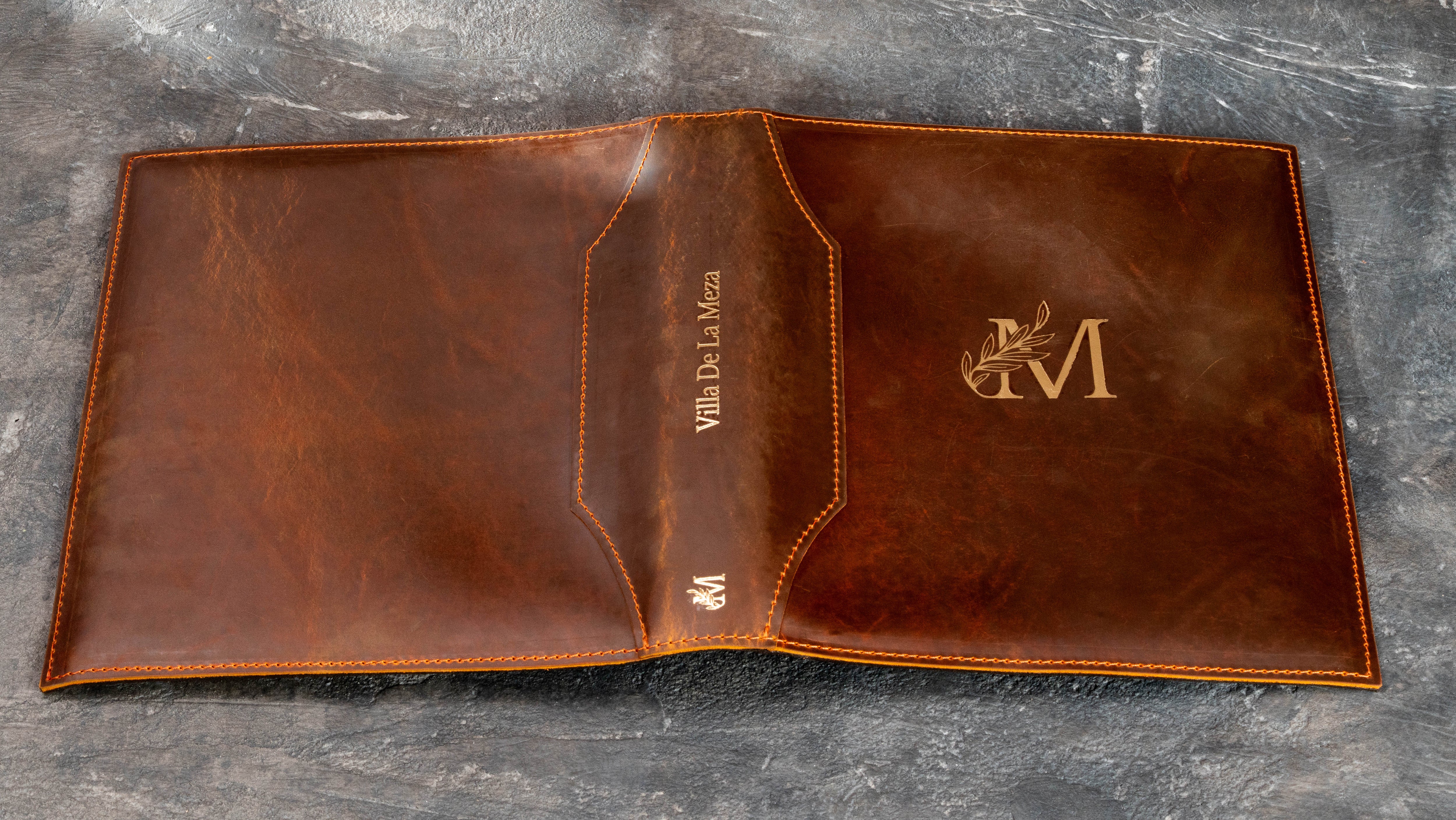 Chestnut leather binder with gold monogram and decorative stitched cover for family memories