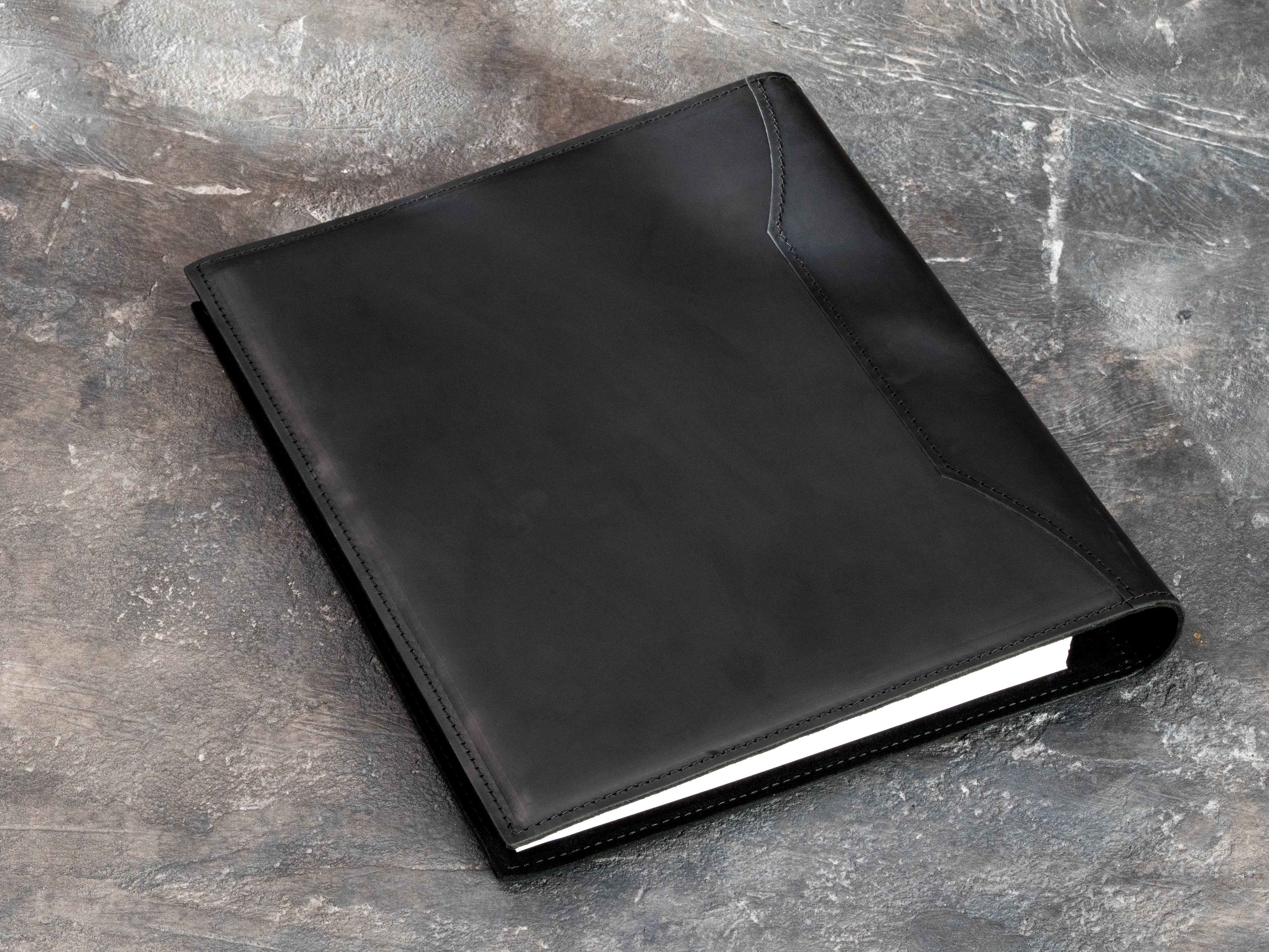 Black leather graduation keepsake binder with embossed college crest, designed for certificates, photos and academic memories