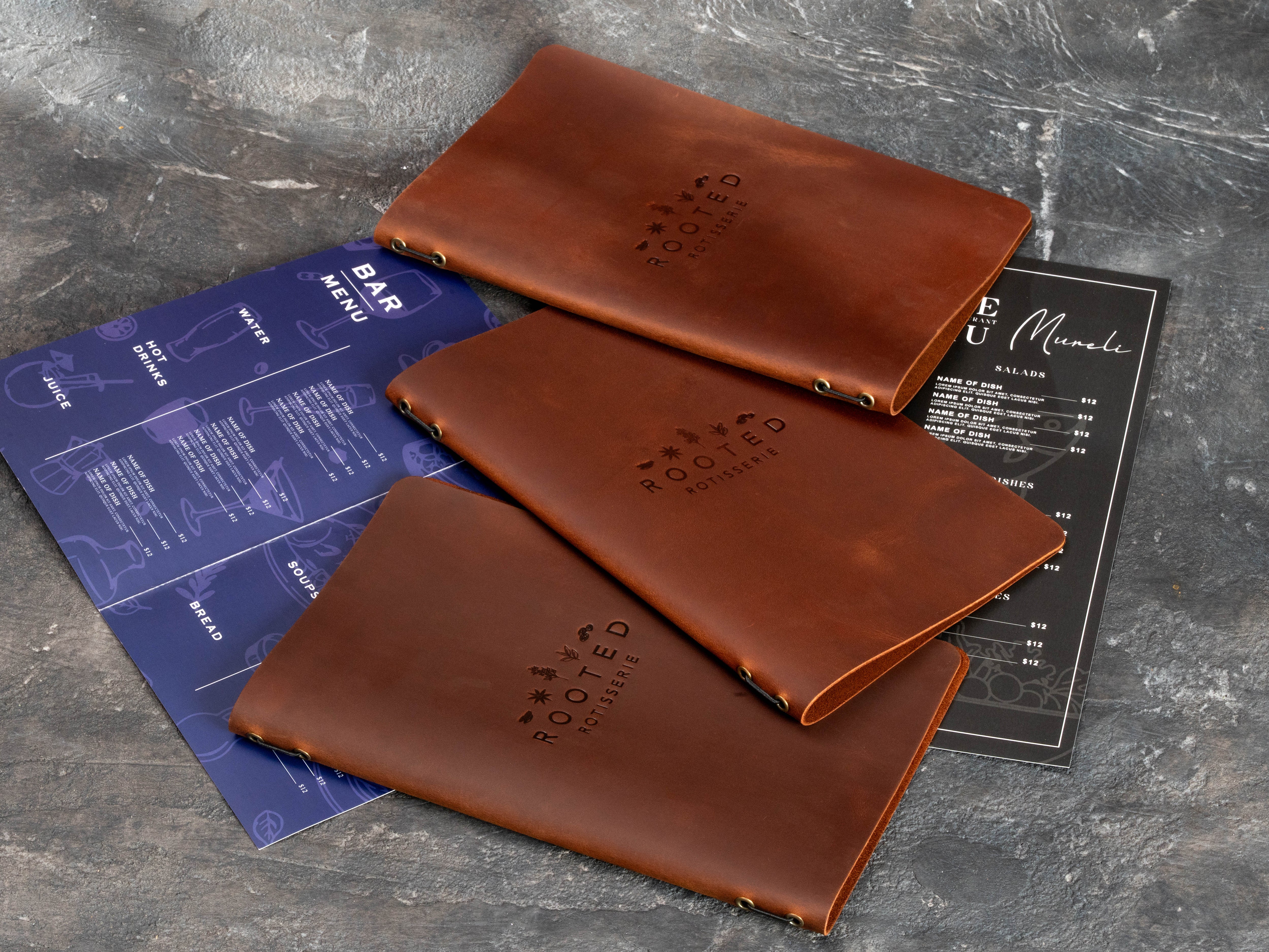 Warm brown branded restaurant menu covers displayed with replaceable food and beverage menu sheets