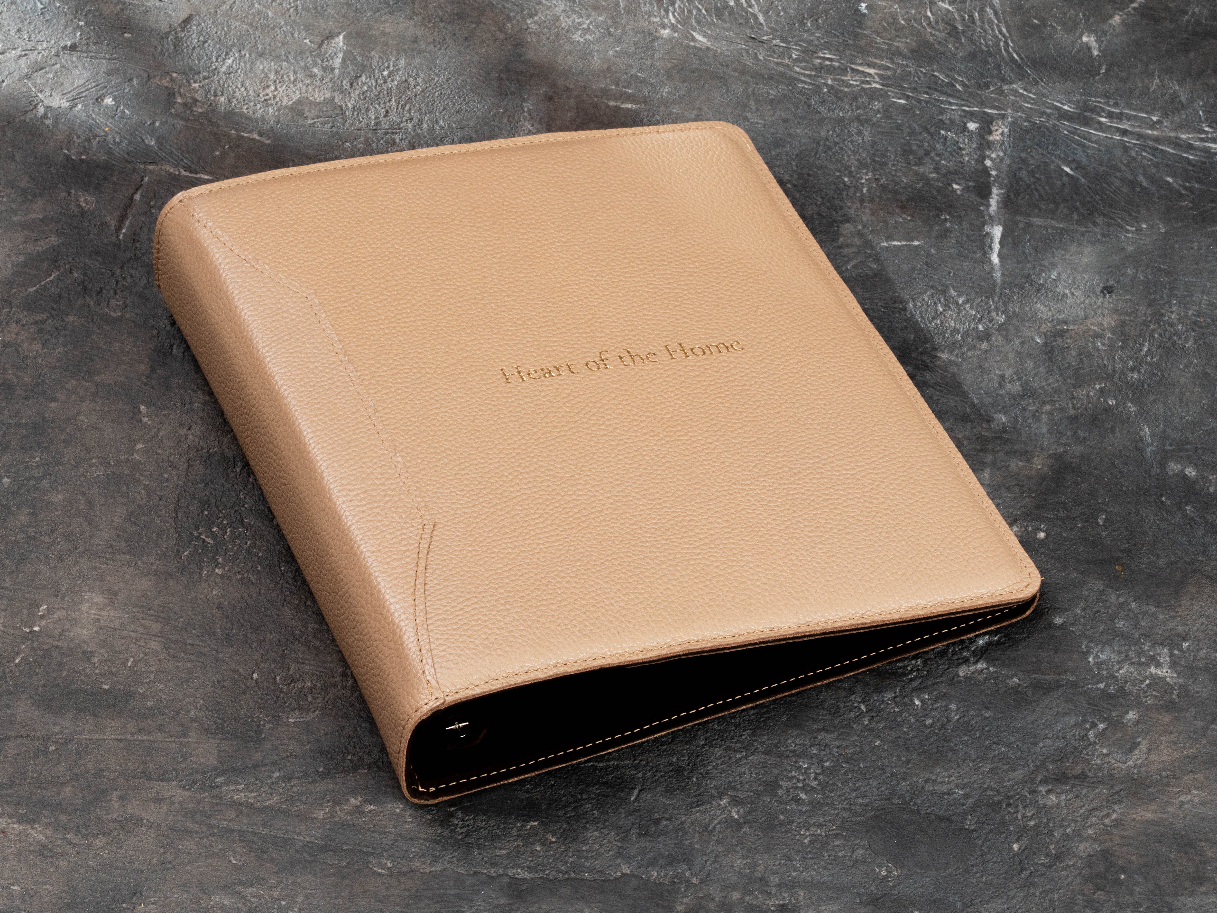 Angled view of a Natural Sand leather ring binder for 8.5 x 11 paper