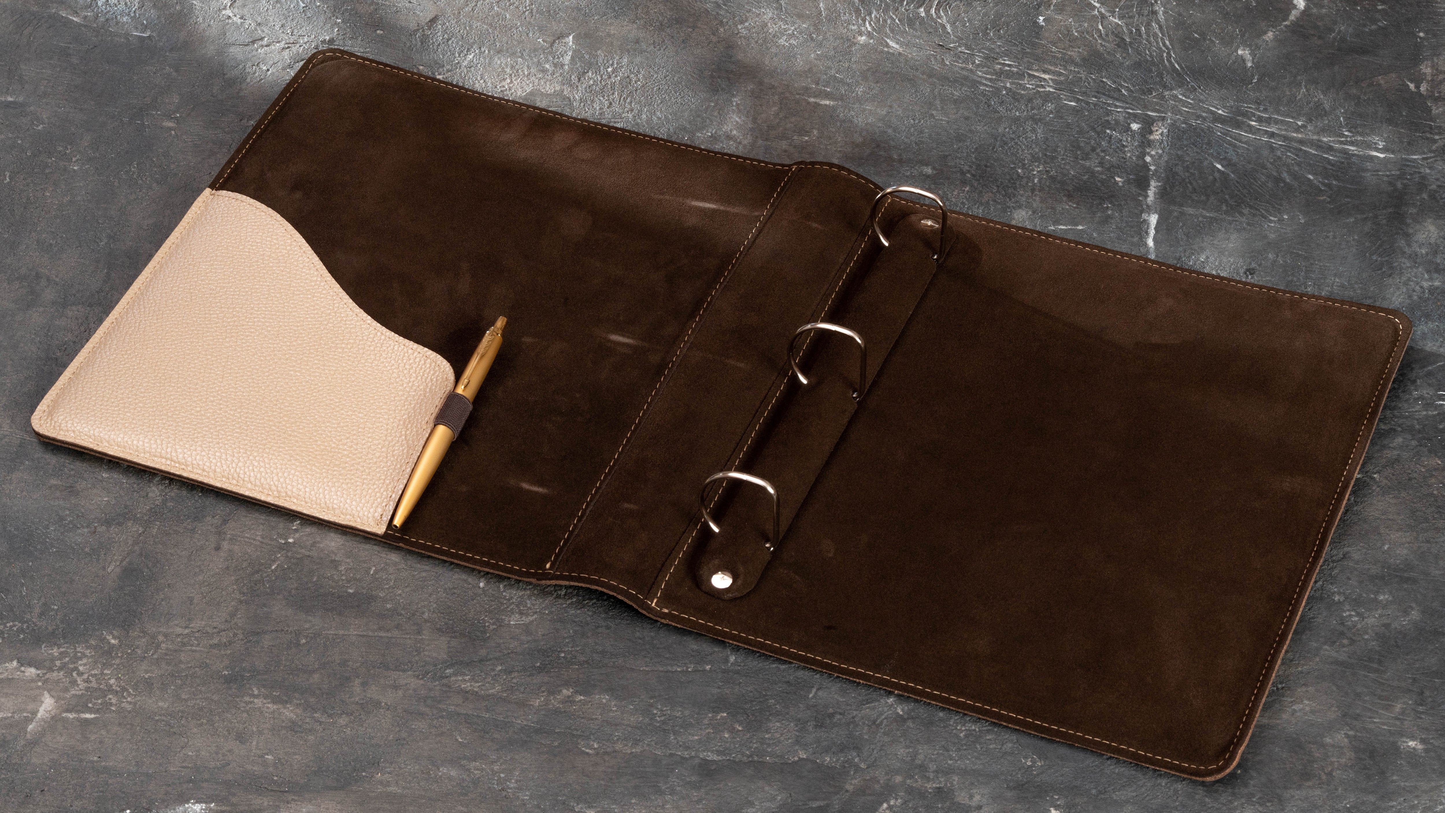 Leather ring binder with interior pocket holding an 8.5 x 11 document