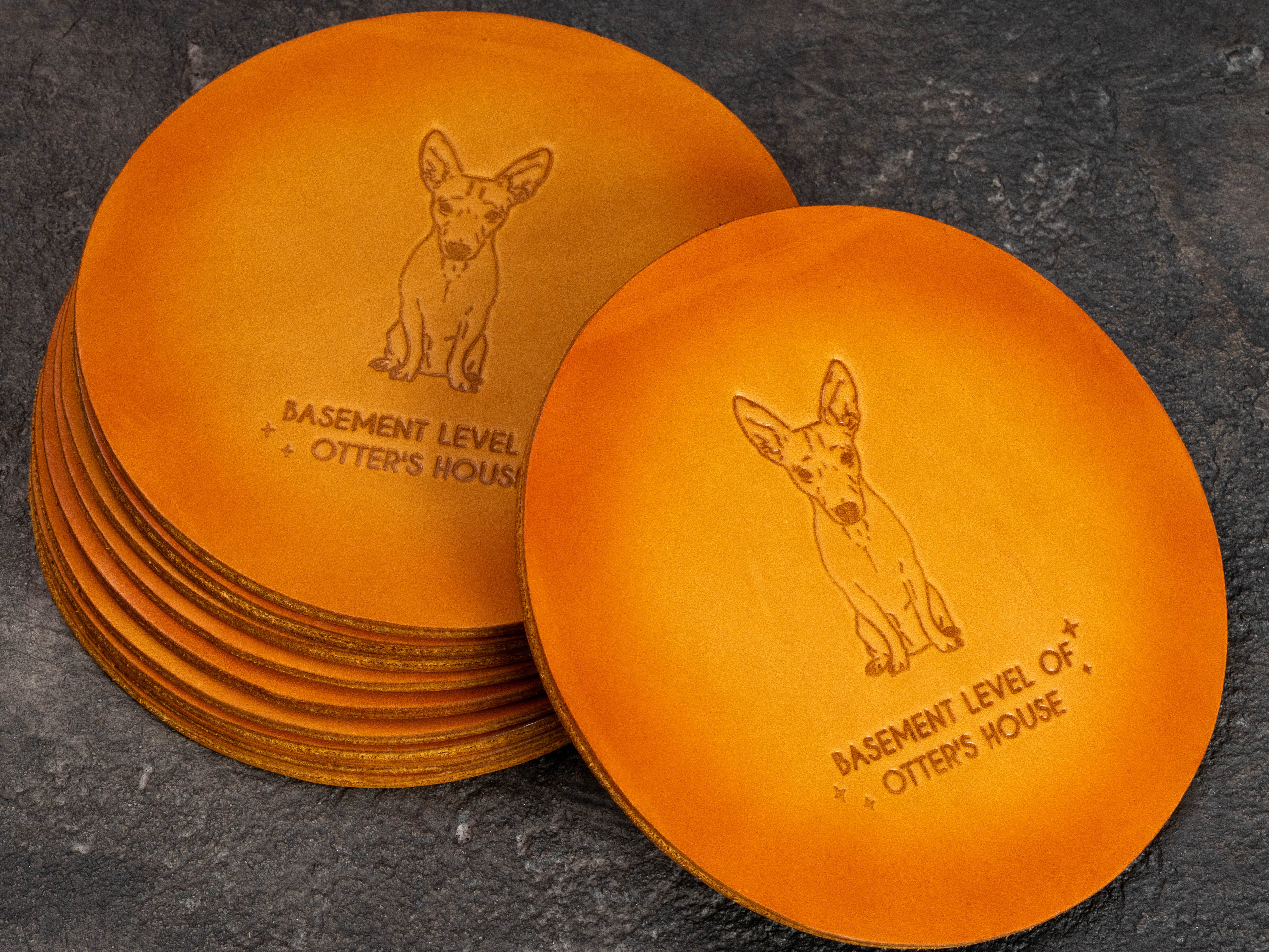 Round personalized leather coaster with custom dog illustration embossing on the reverse side