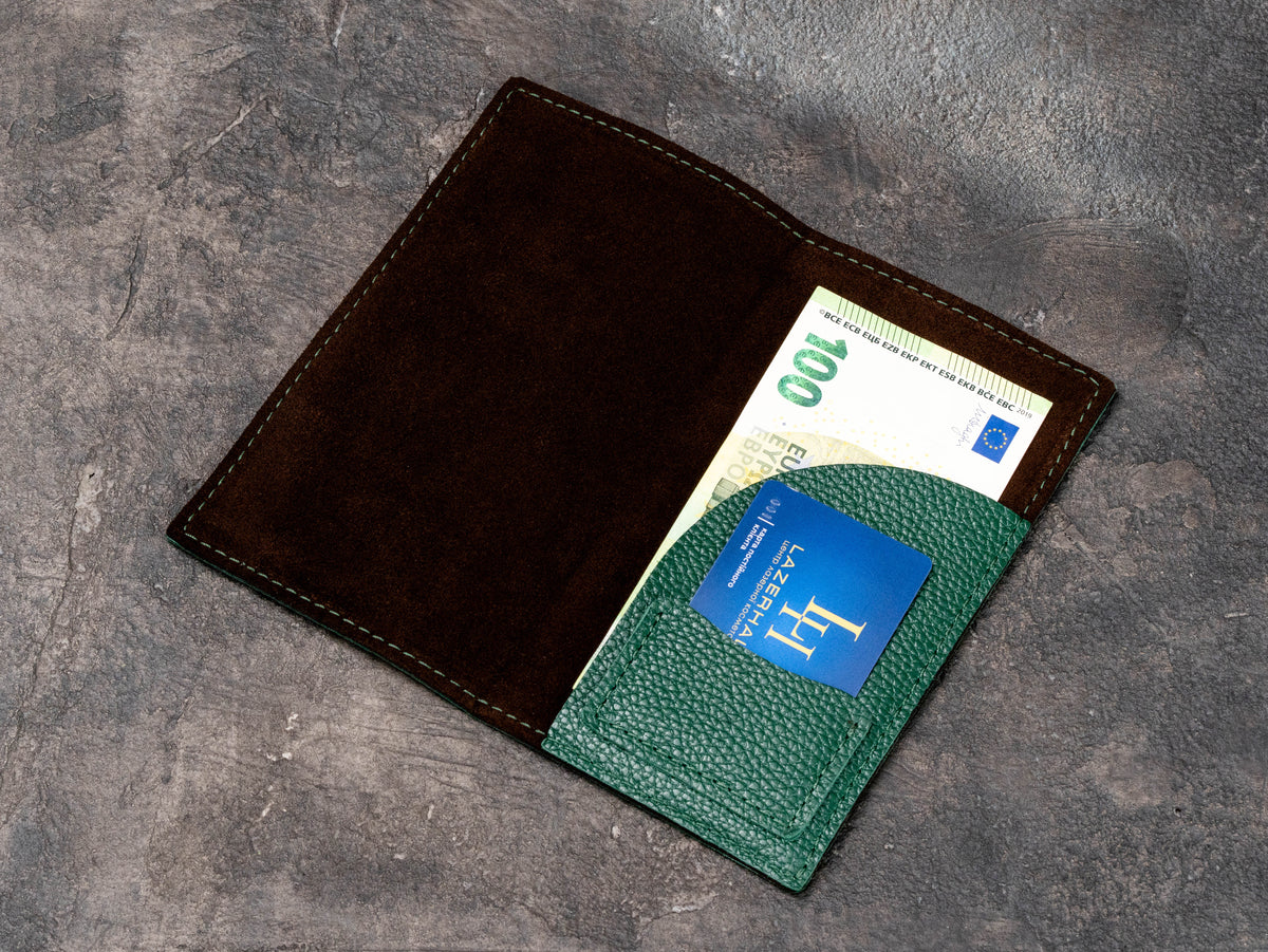 Green leather check presenter with suede interior holding euro cash and a business card