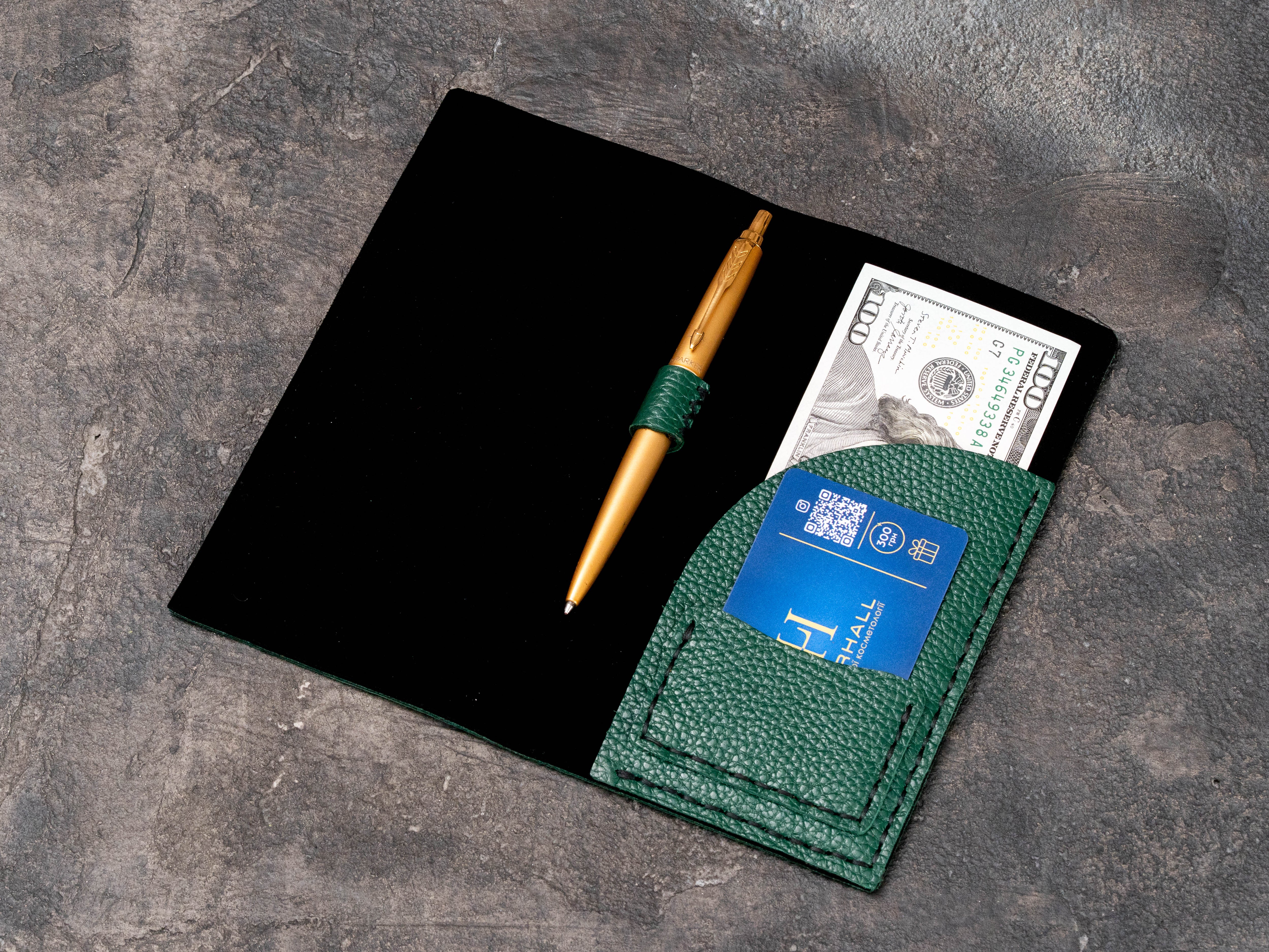 Back view of green floater leather restaurant check presenter with clean minimalist exterior