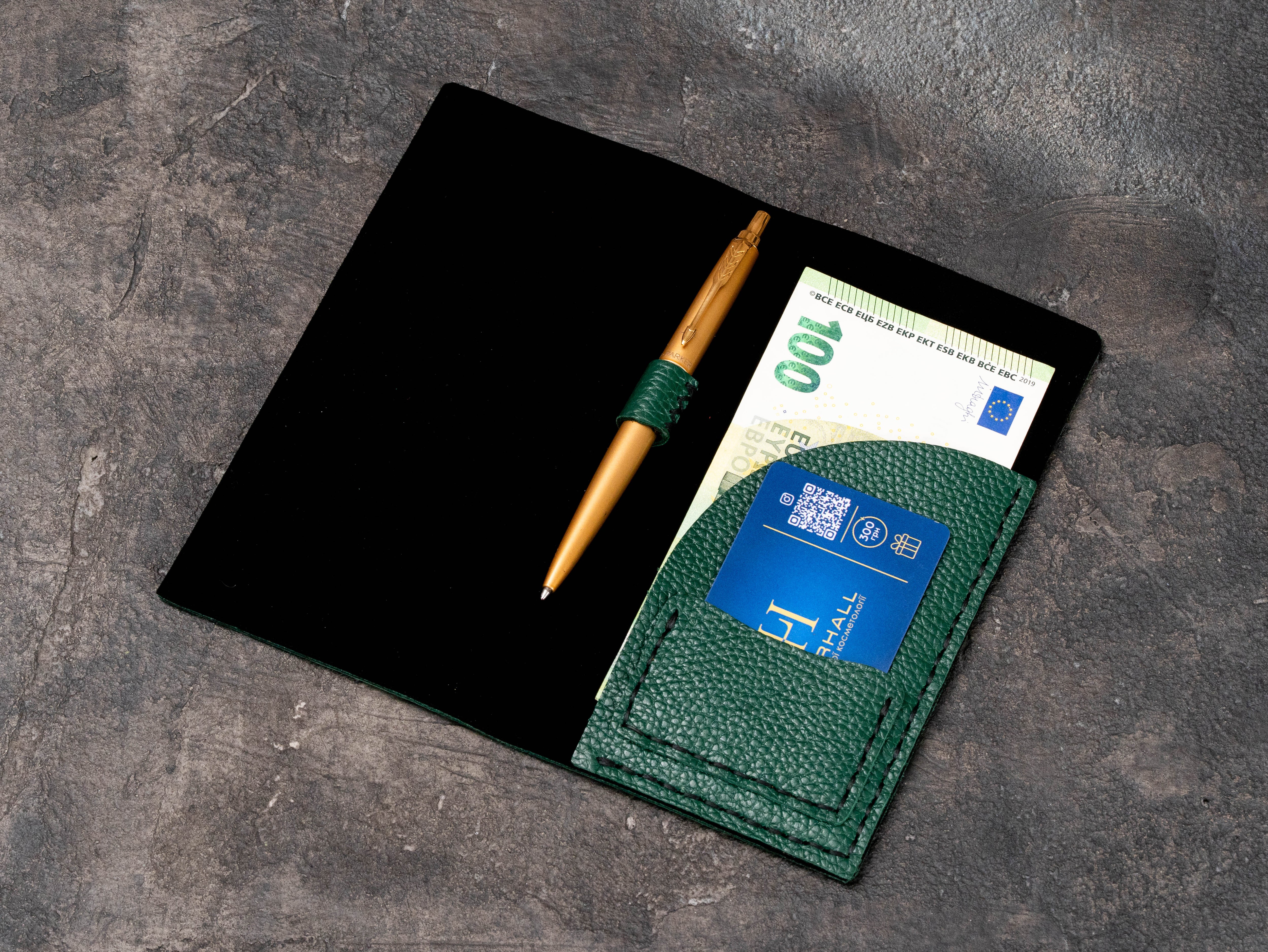 Open green floater leather bill presenter with suede interior, pen holder, card pocket and euro banknote