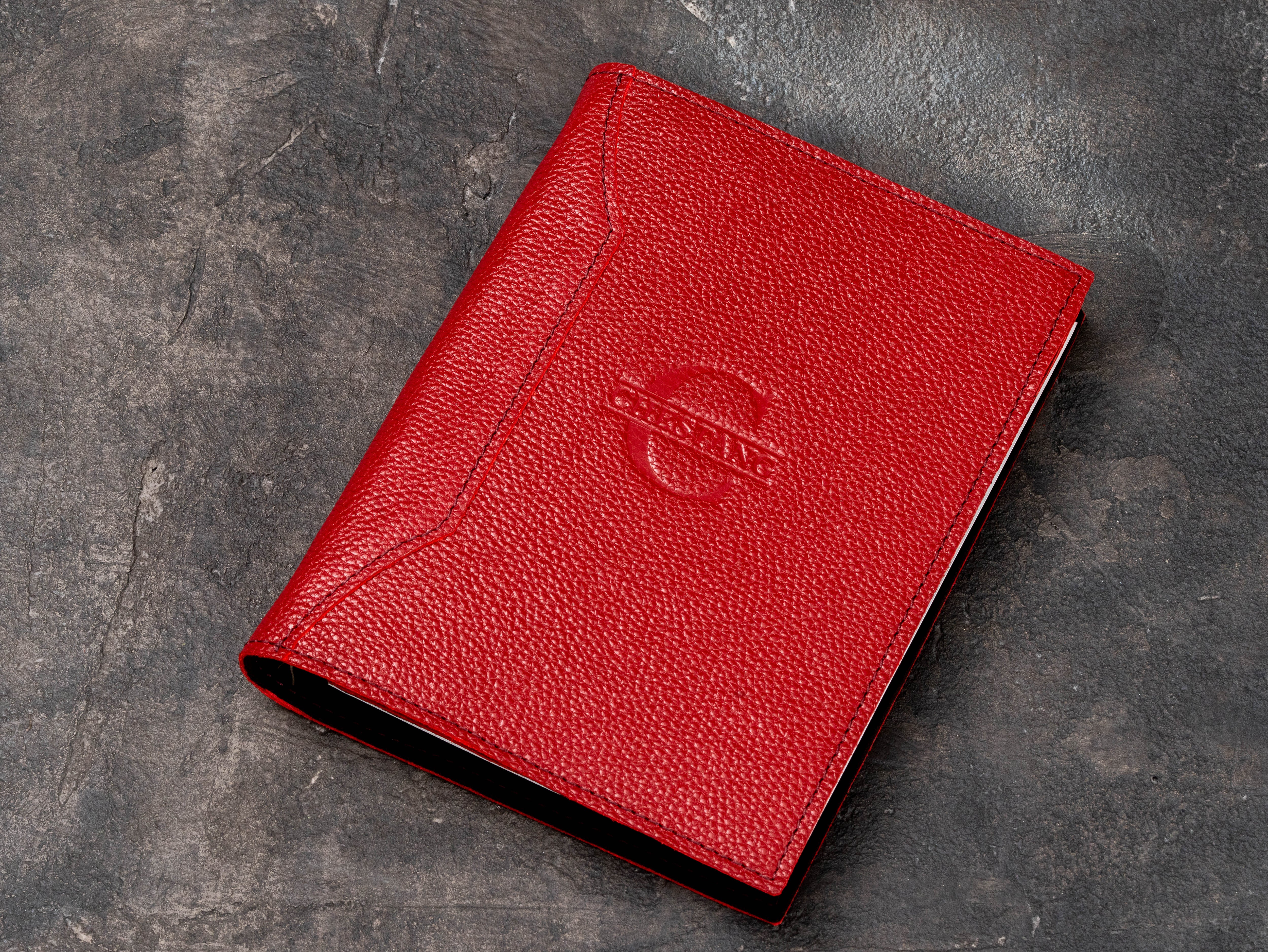 Red floater leather corporate ring binder notebook organizer with subtle embossed private label client logo.