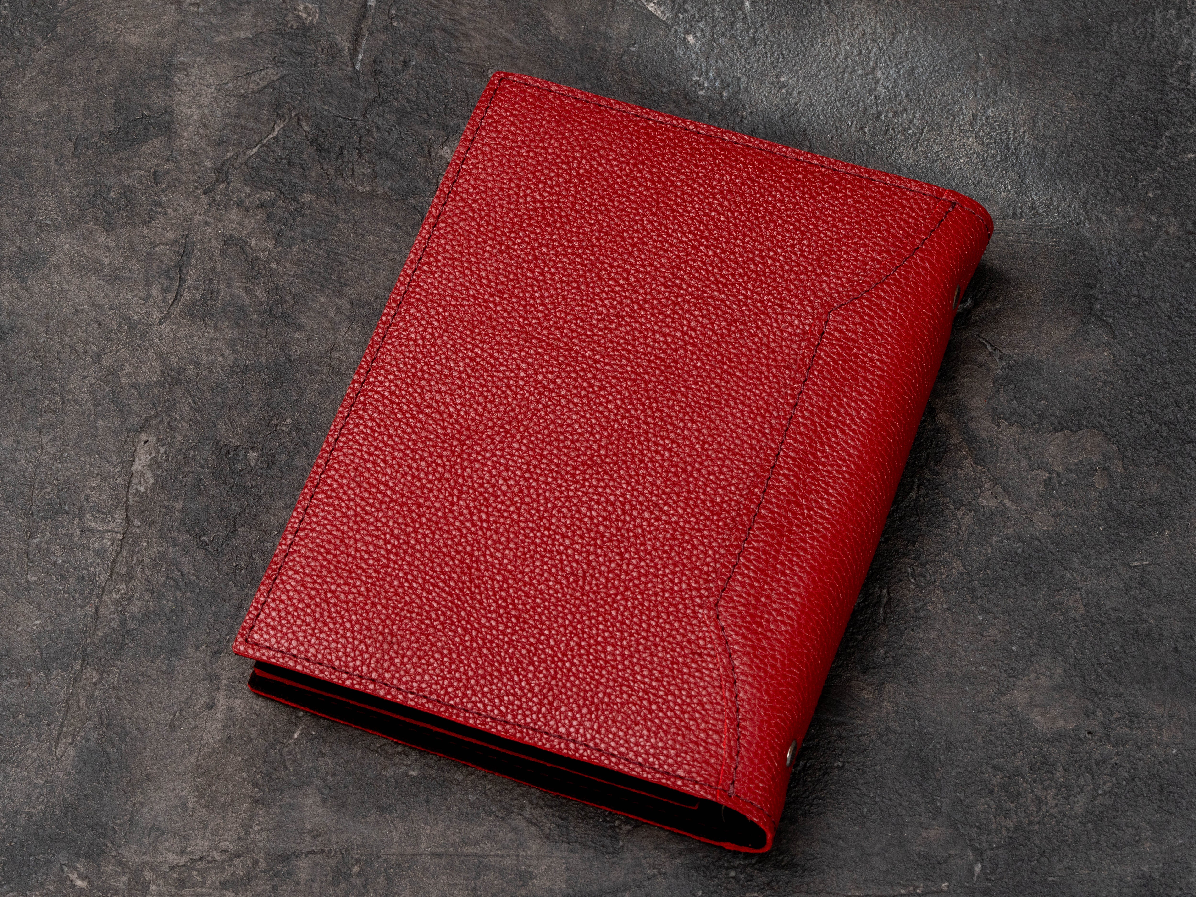 Back view of red floater leather notebook organizer showing textured leather, stitched edges and dark suede interior.