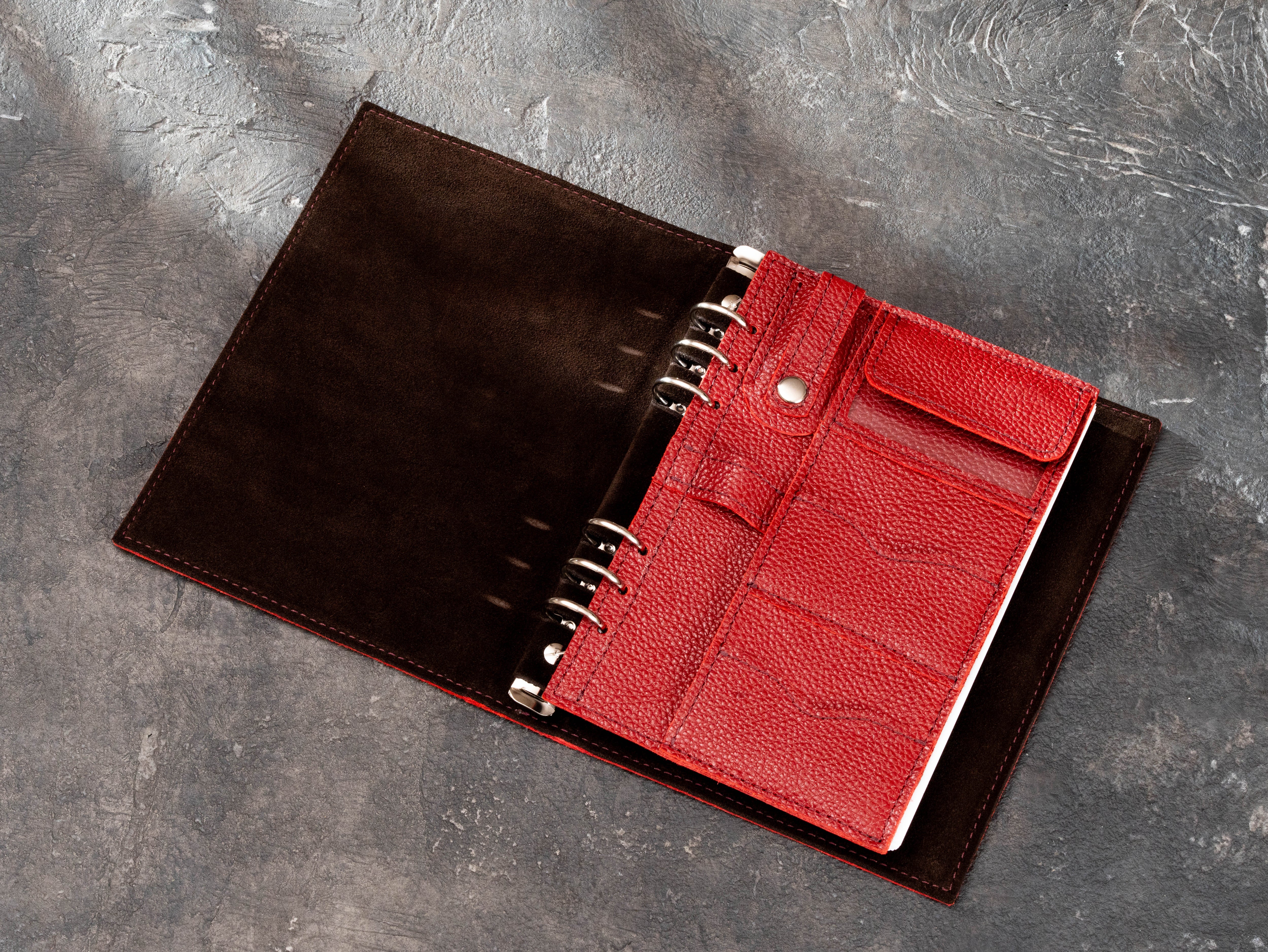 Red floater leather ring-mounted organizer insert with multiple card slots, USB pocket, hidden paper compartment and pen holder.