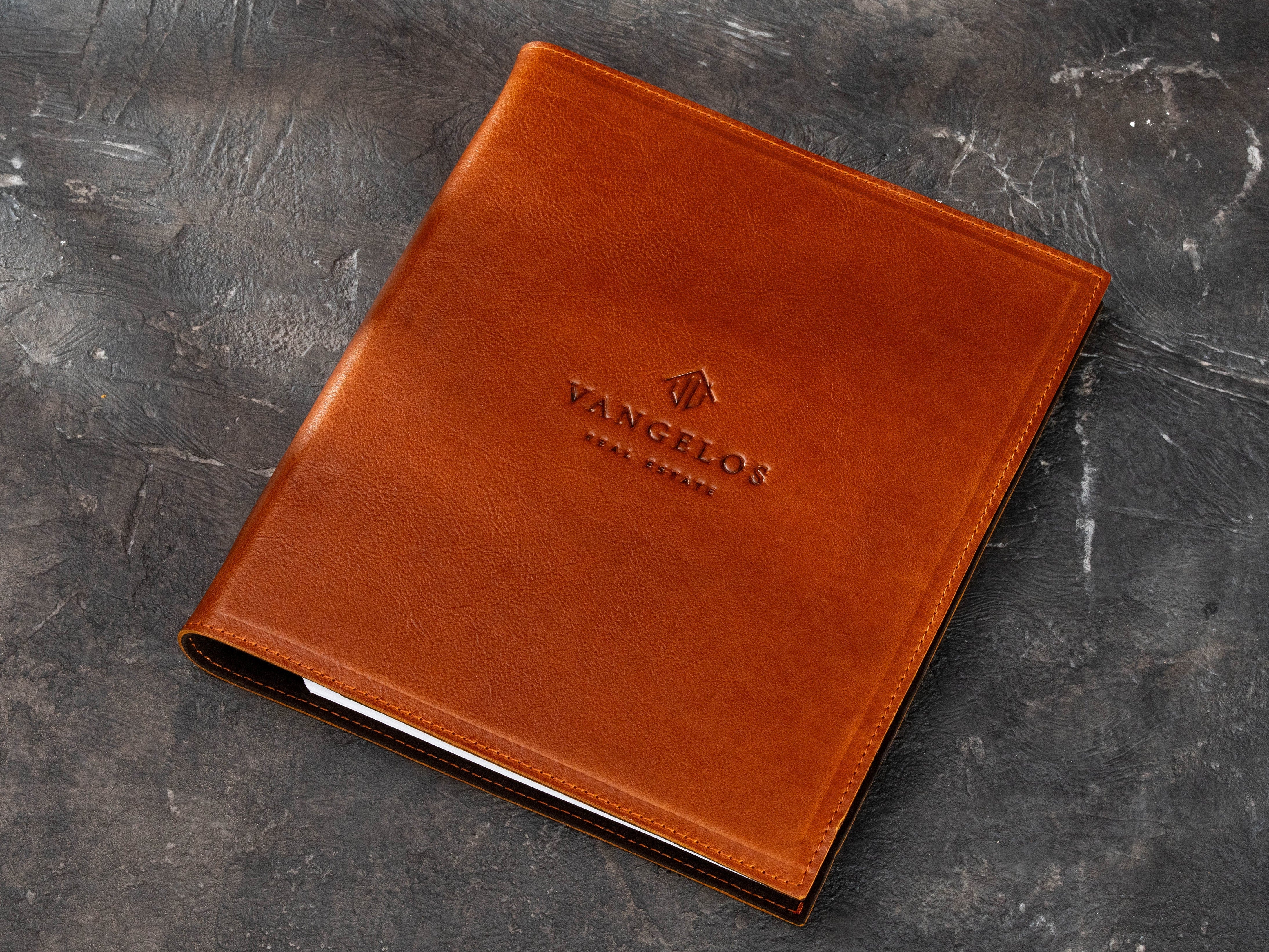 Custom leather real estate binder with branded front cover, designed for A4 and 8.5 x 11 inch documents.