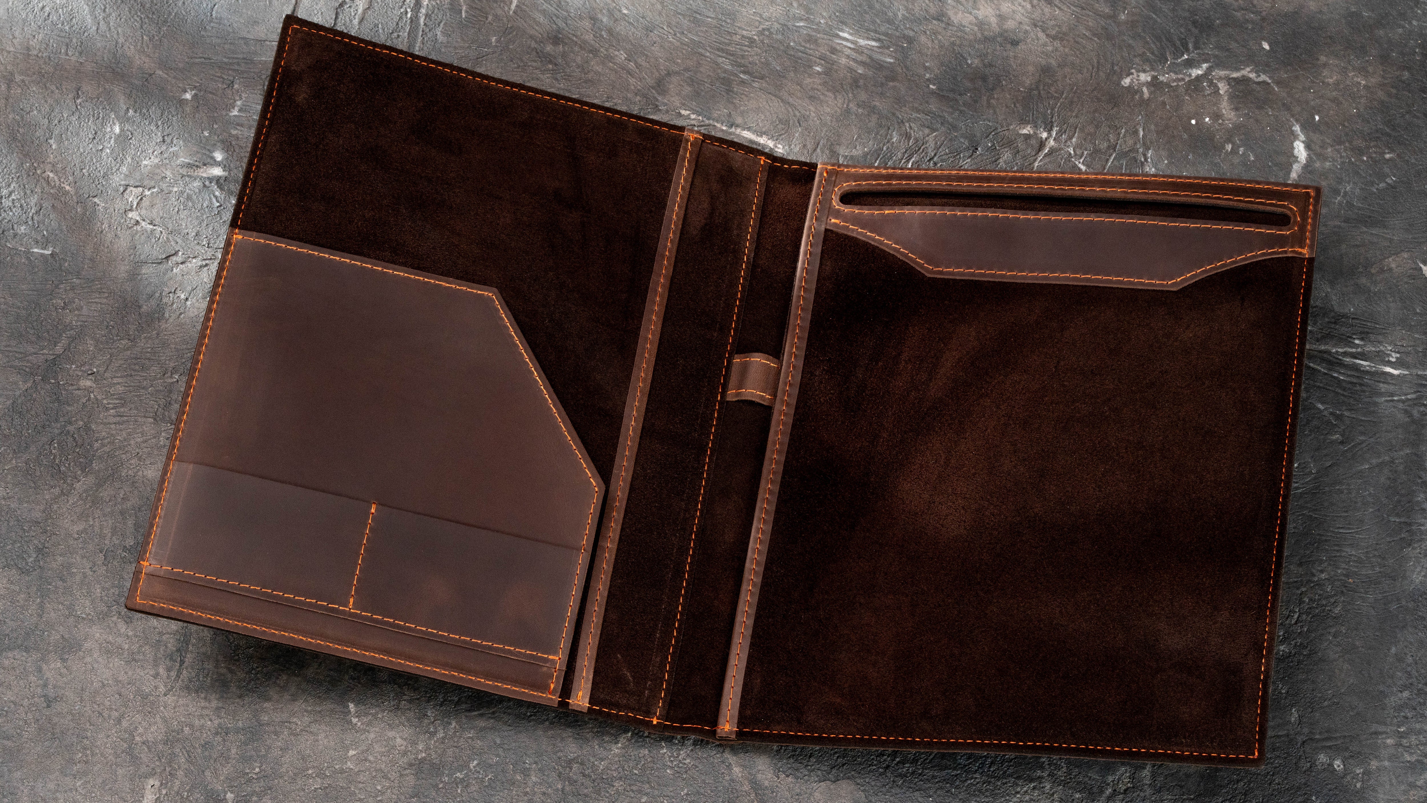 Open brown leather Legal Pad portfolio with dark suede interior, large document pocket, card slots, pen holder and replaceable writing pad slot.