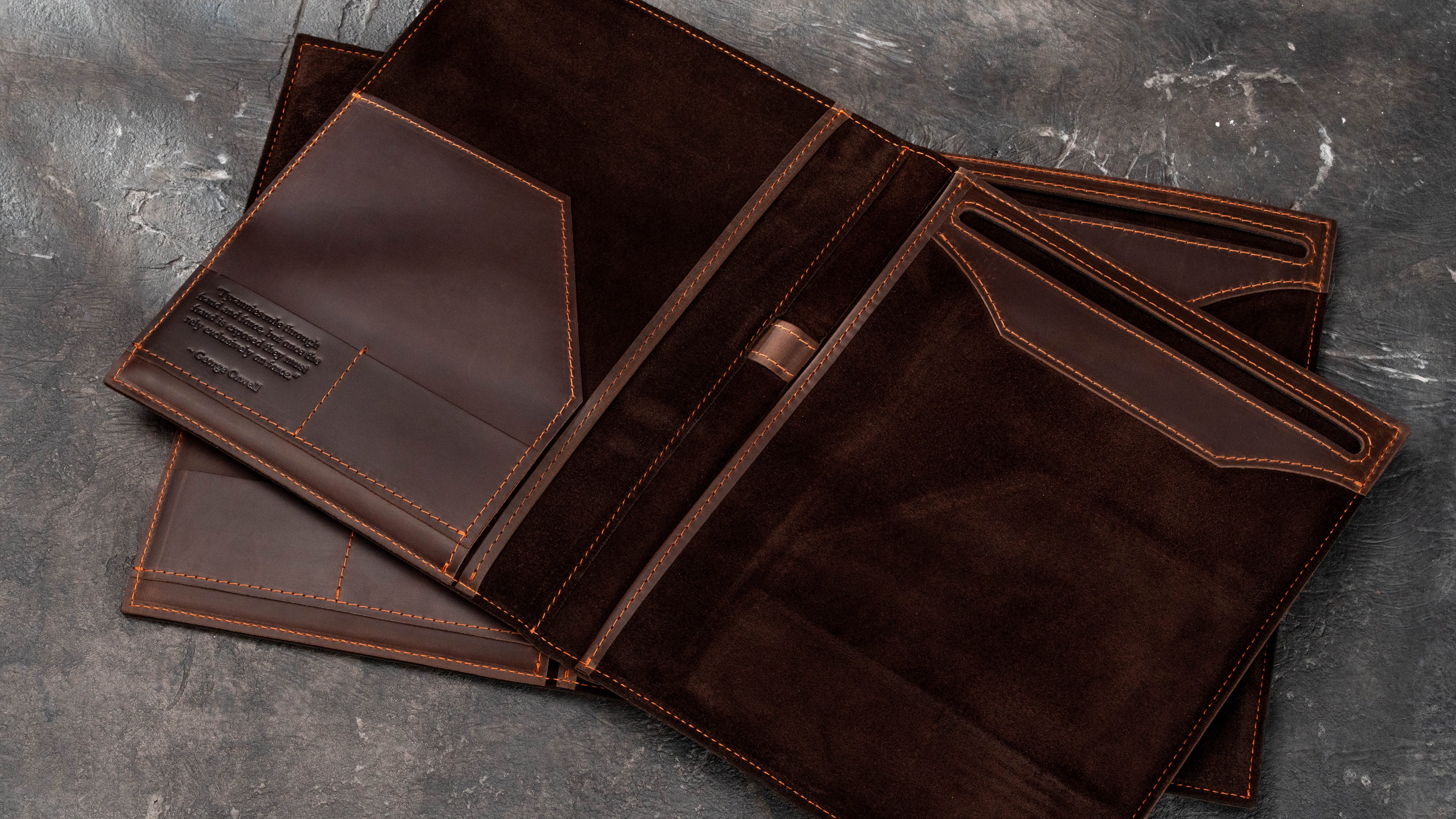 Two open custom leather business padfolios showing suede interiors, Legal Pad holders, document pockets and different corporate personalization options.