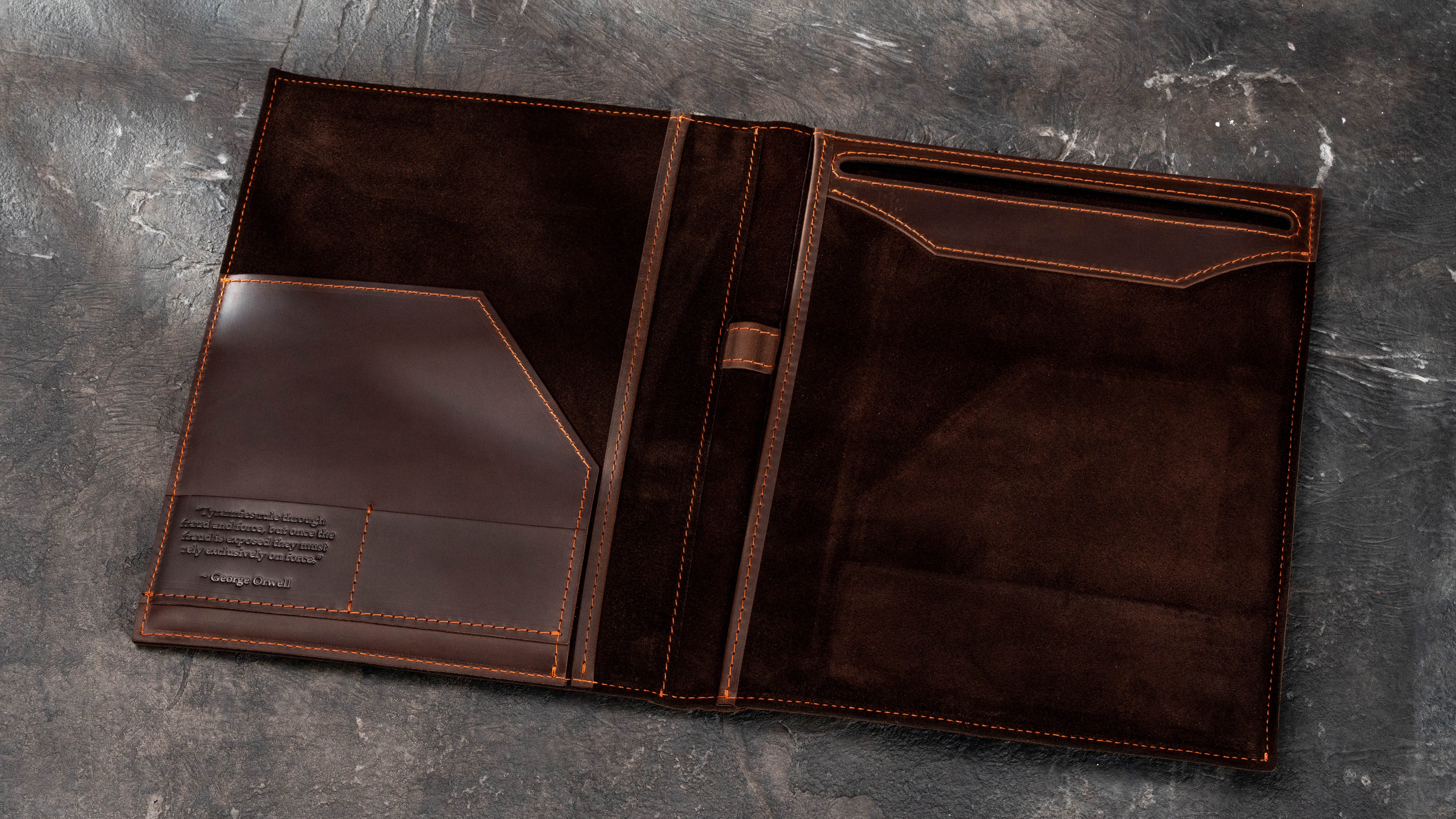 Open dark brown leather Legal Pad padfolio with embossed interior quote, document pocket, card slots, pen loop and suede lining.