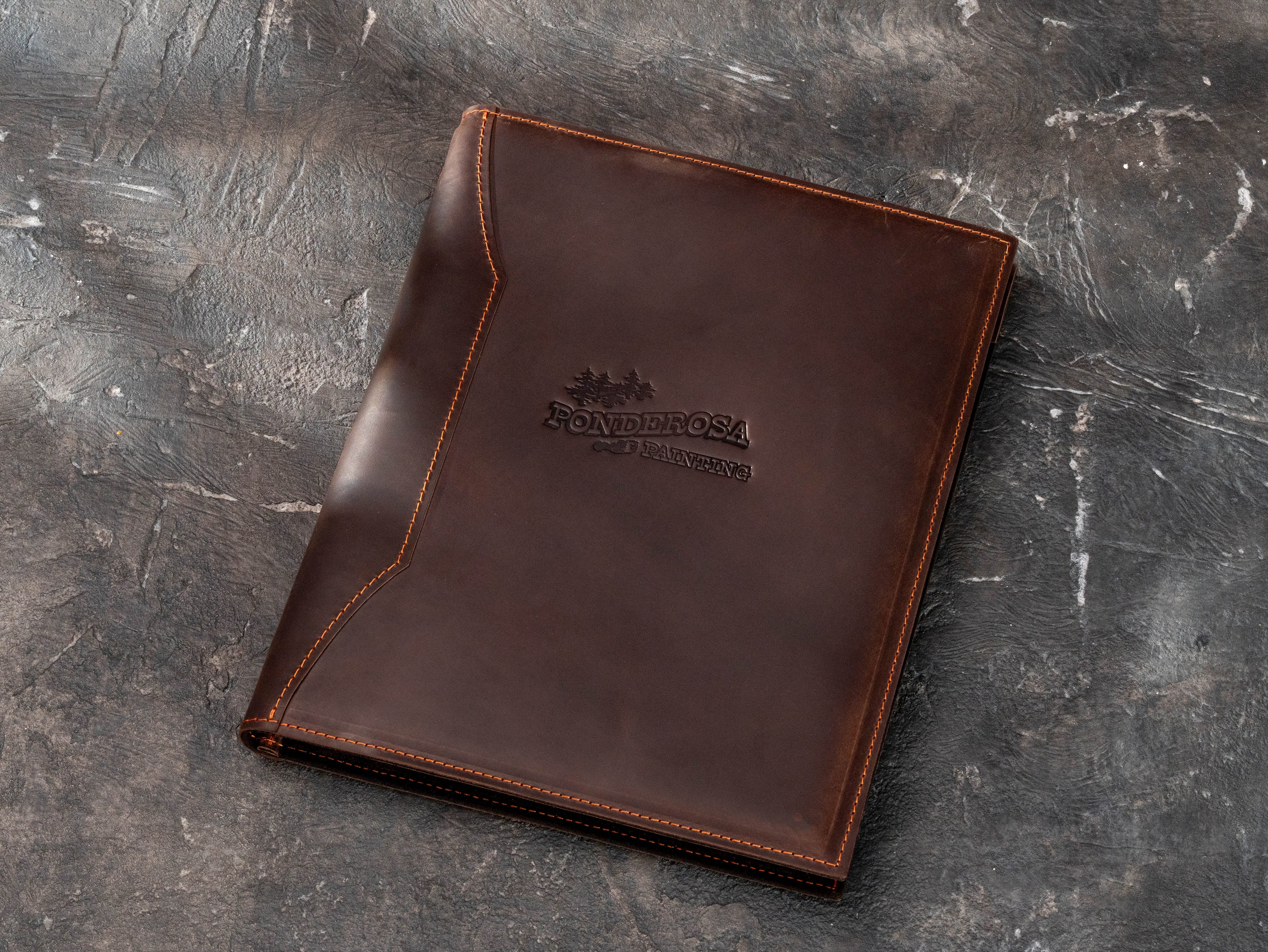Dark brown leather contractor padfolio with custom embossed company logo, contrast stitching and professional Legal Pad portfolio design.