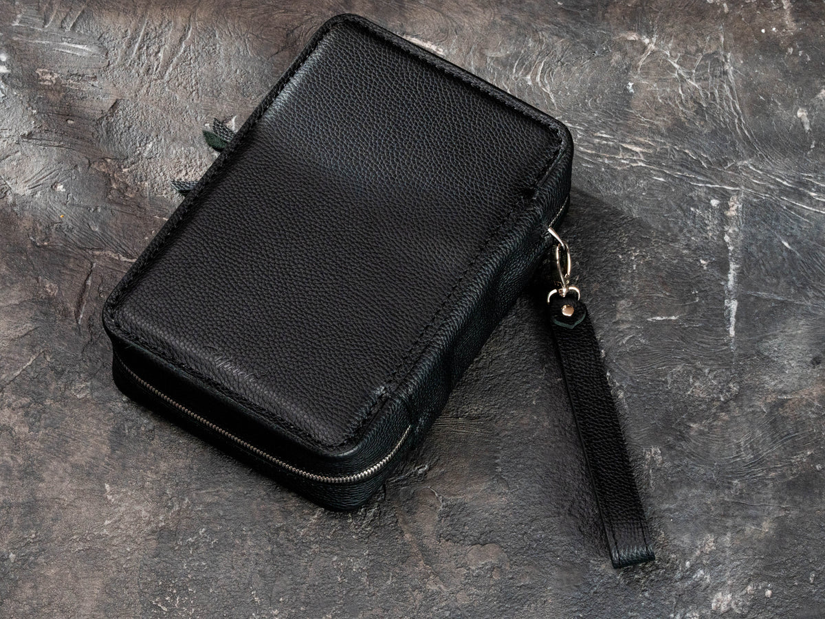 Back view of premium black Floater leather cigar organizer with dual zipper closure and removable leather wrist strap.
