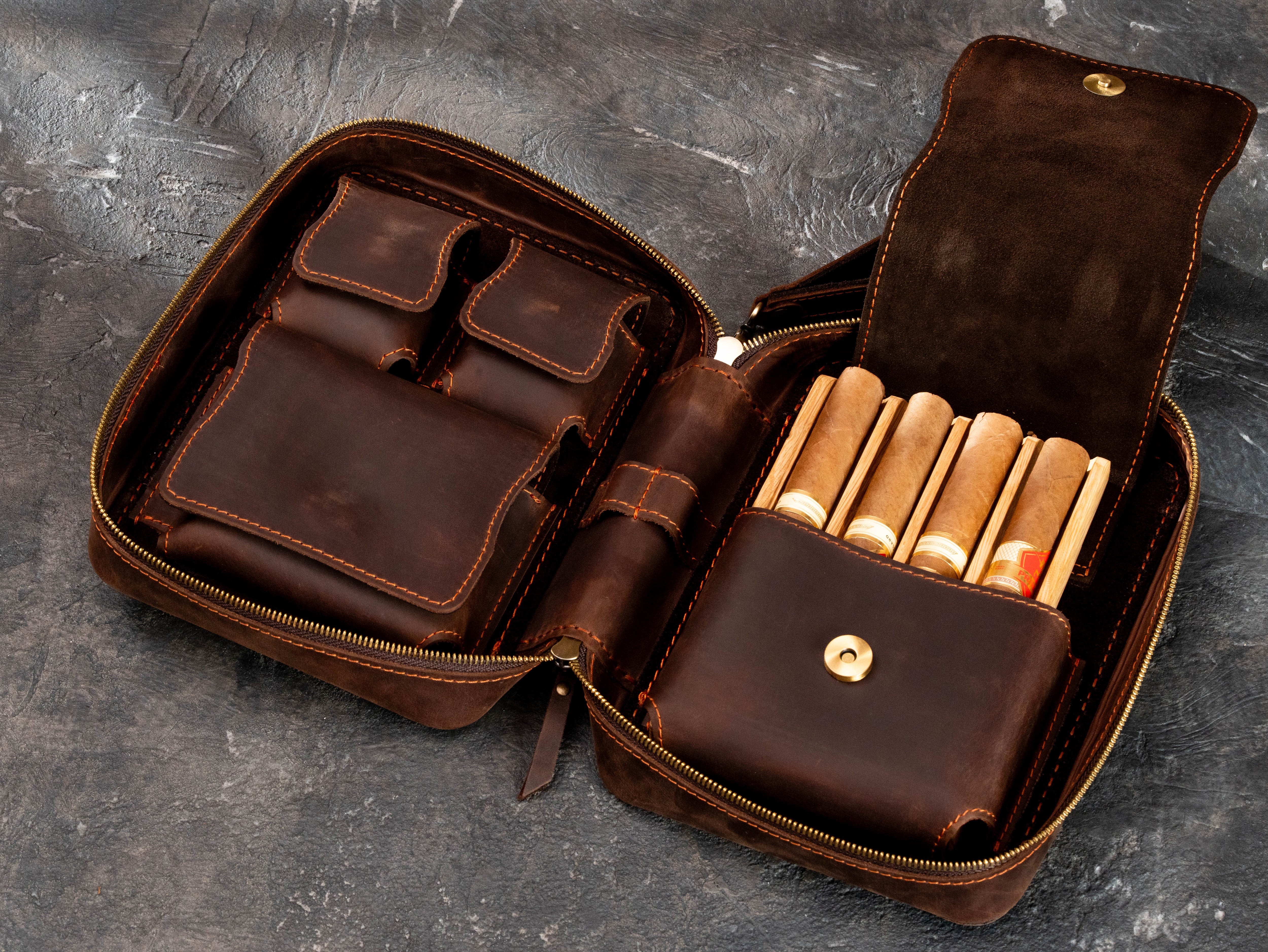 Brown leather cigar case with four cigars in removable oak tray, suede-backed magnetic flap and separate accessory compartments.