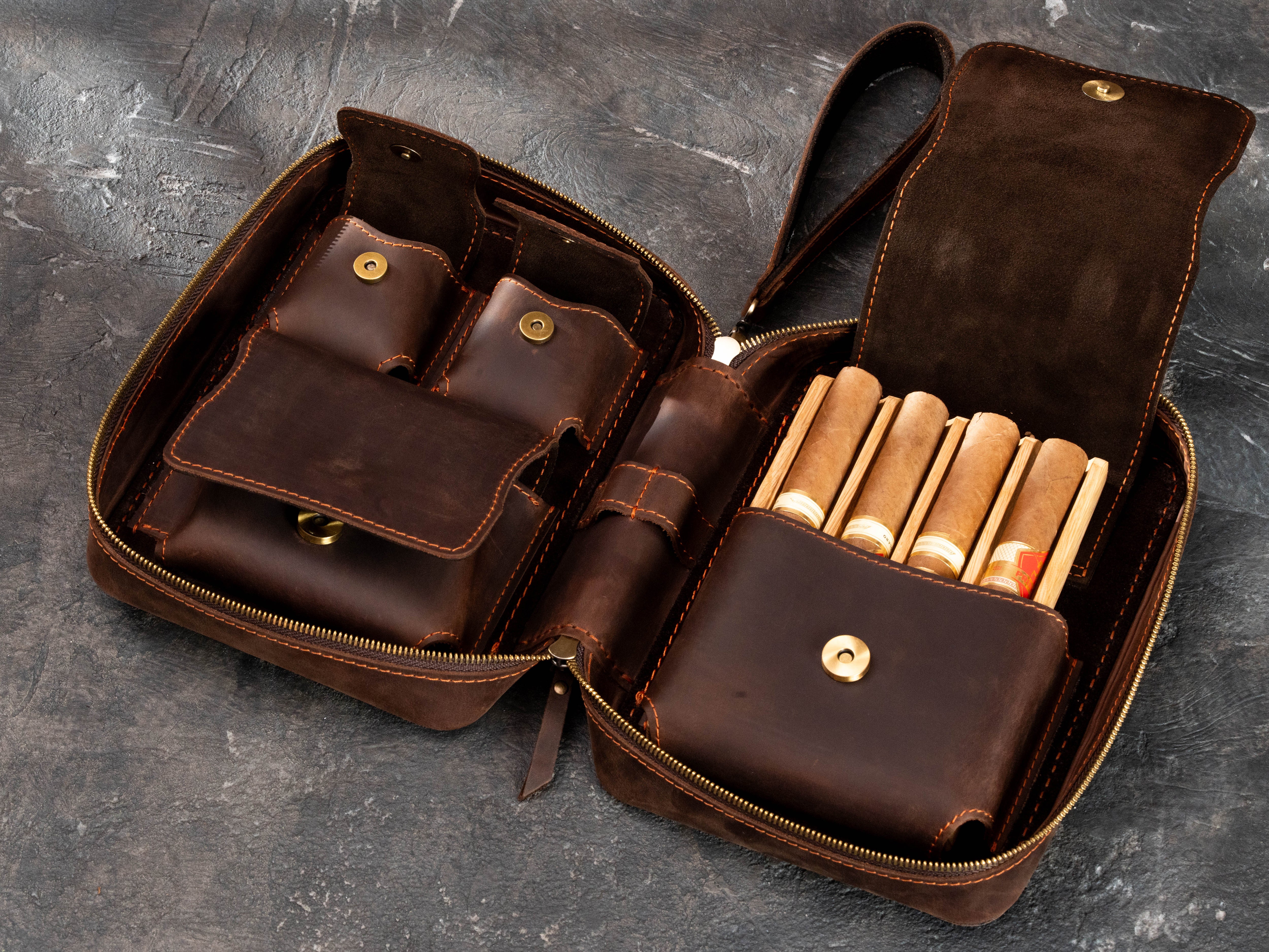 Premium brown leather cigar organizer with open suede-lined accessory compartment, magnetic closures and removable oak tray for four cigars.