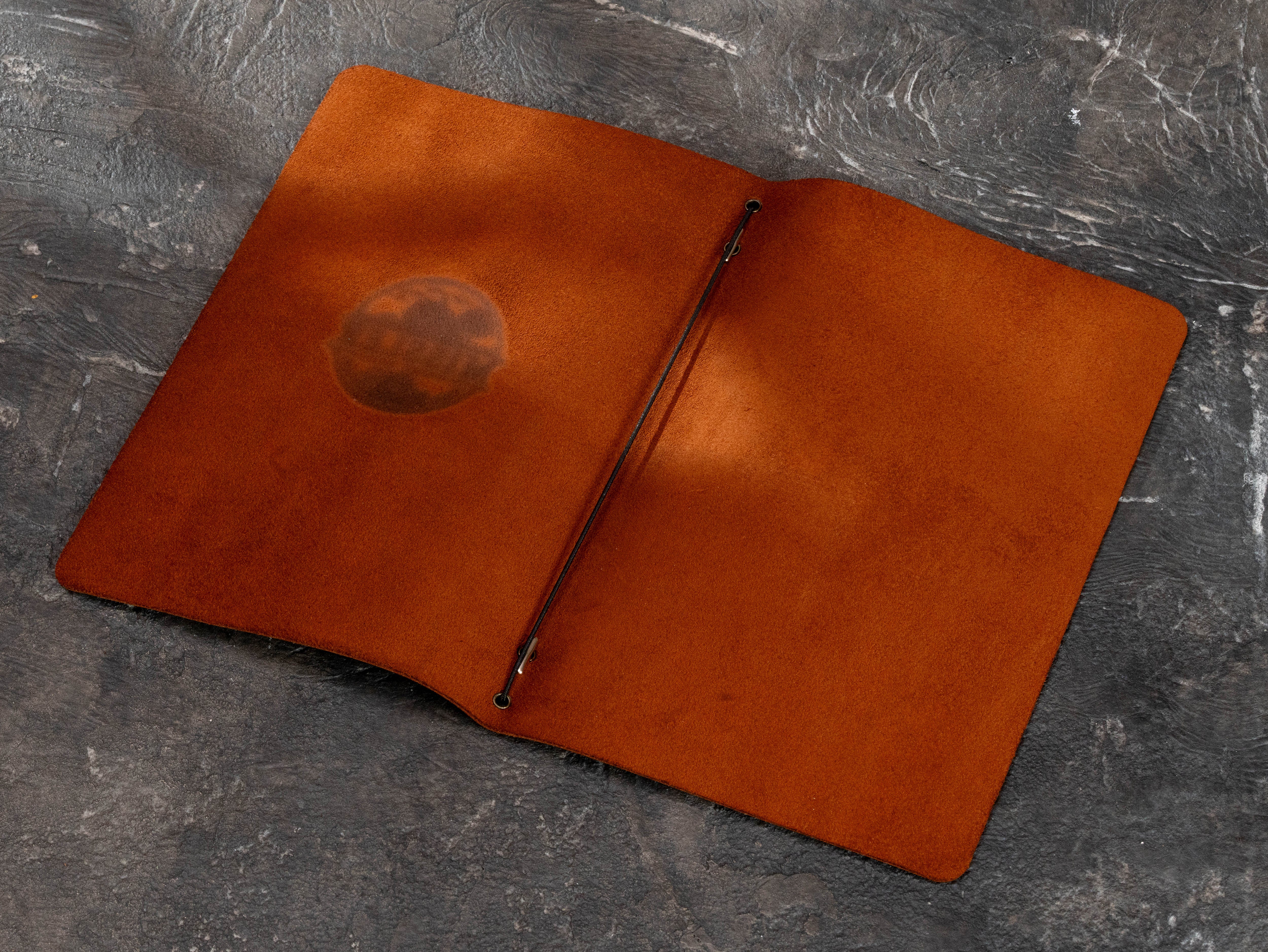 Open brown leather home bar menu cover with elastic cord binding and warm suede interior for folded 8.5 x 11 inch menu paper.