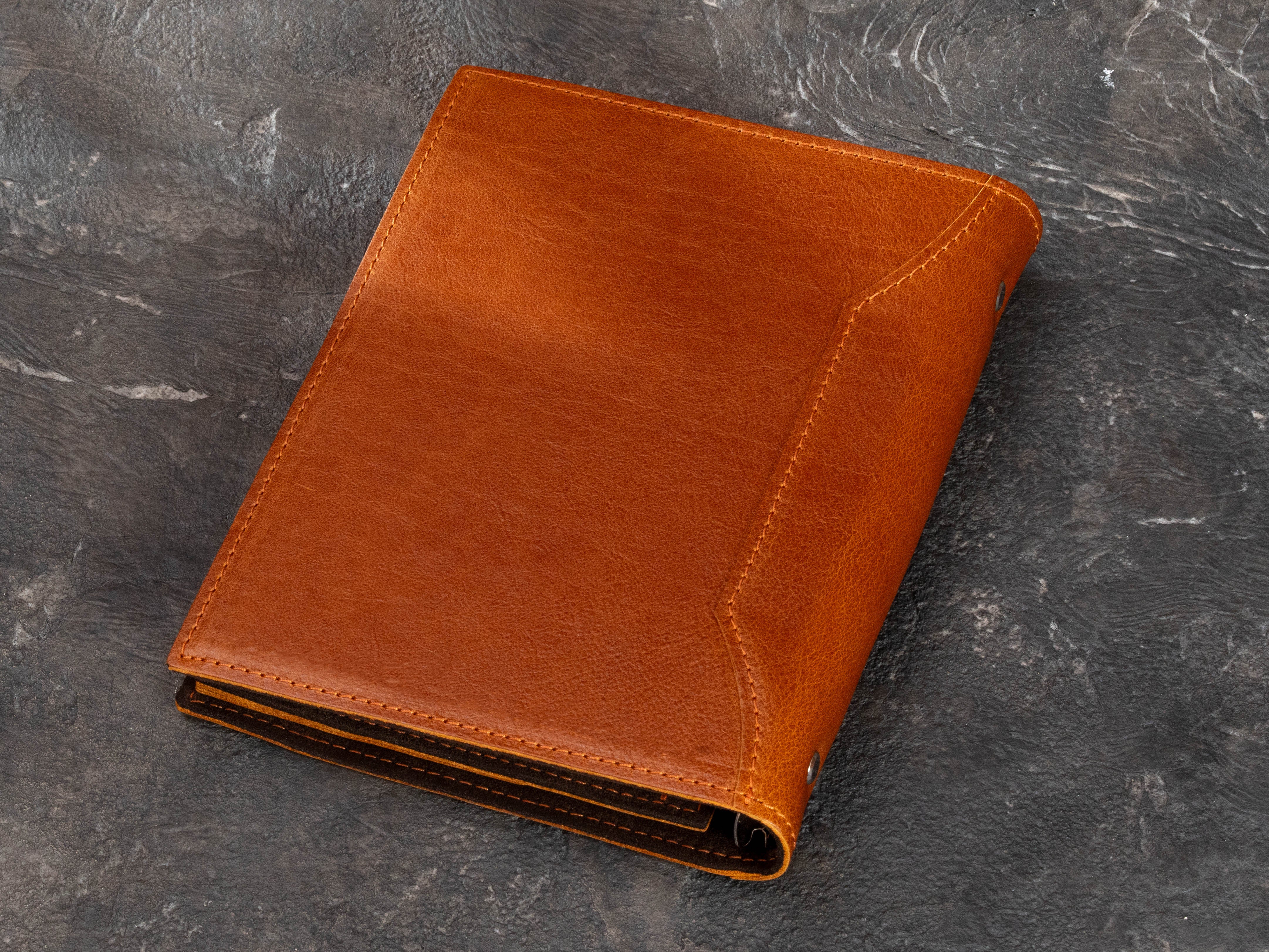 Back view of Camel leather A5 journal binder with stitched cover, rounded spine and dark suede interior construction.