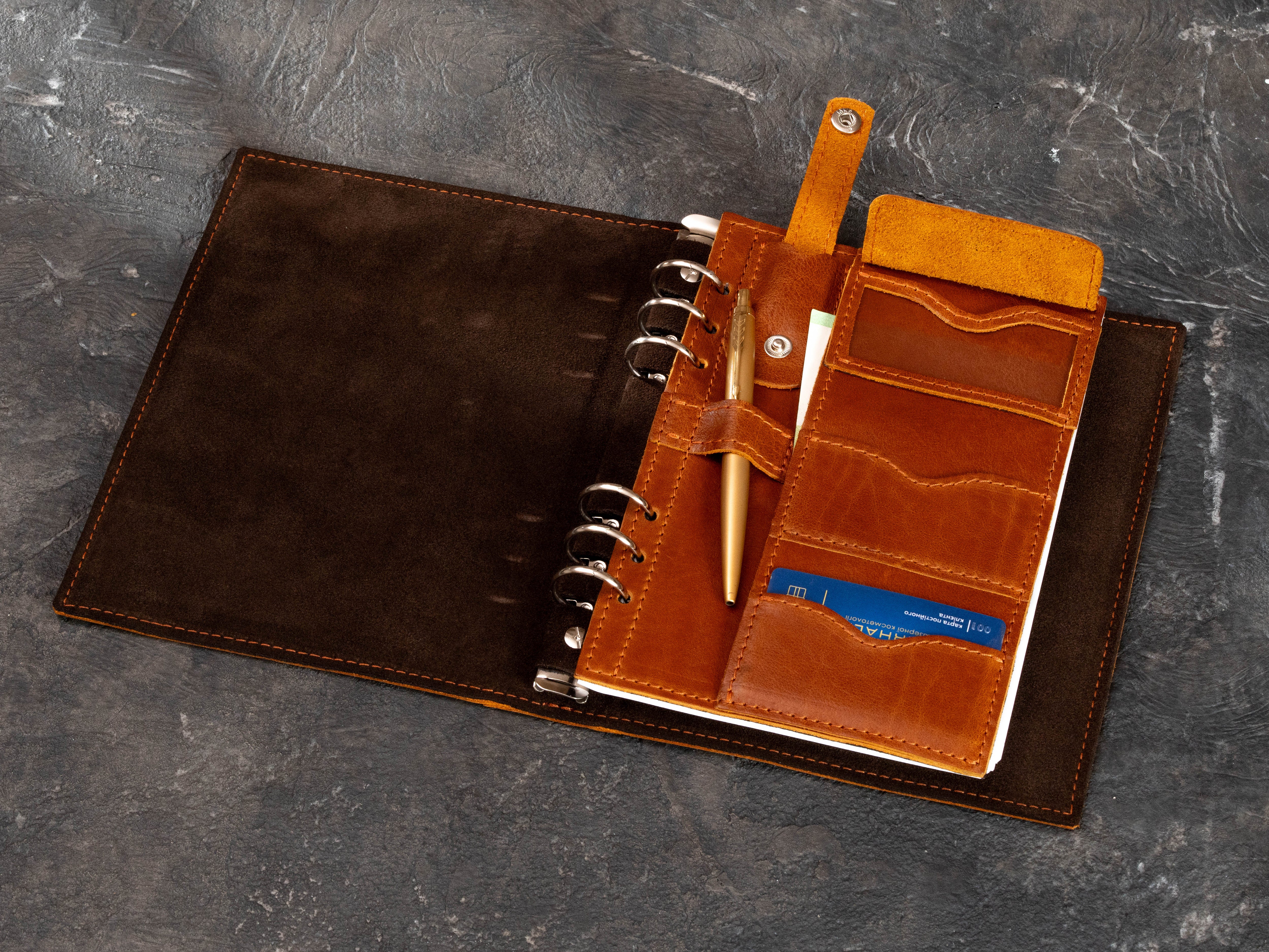 Camel leather business notebook organizer with pen loop, card pockets, flap compartment and refillable 6-ring binder interior.