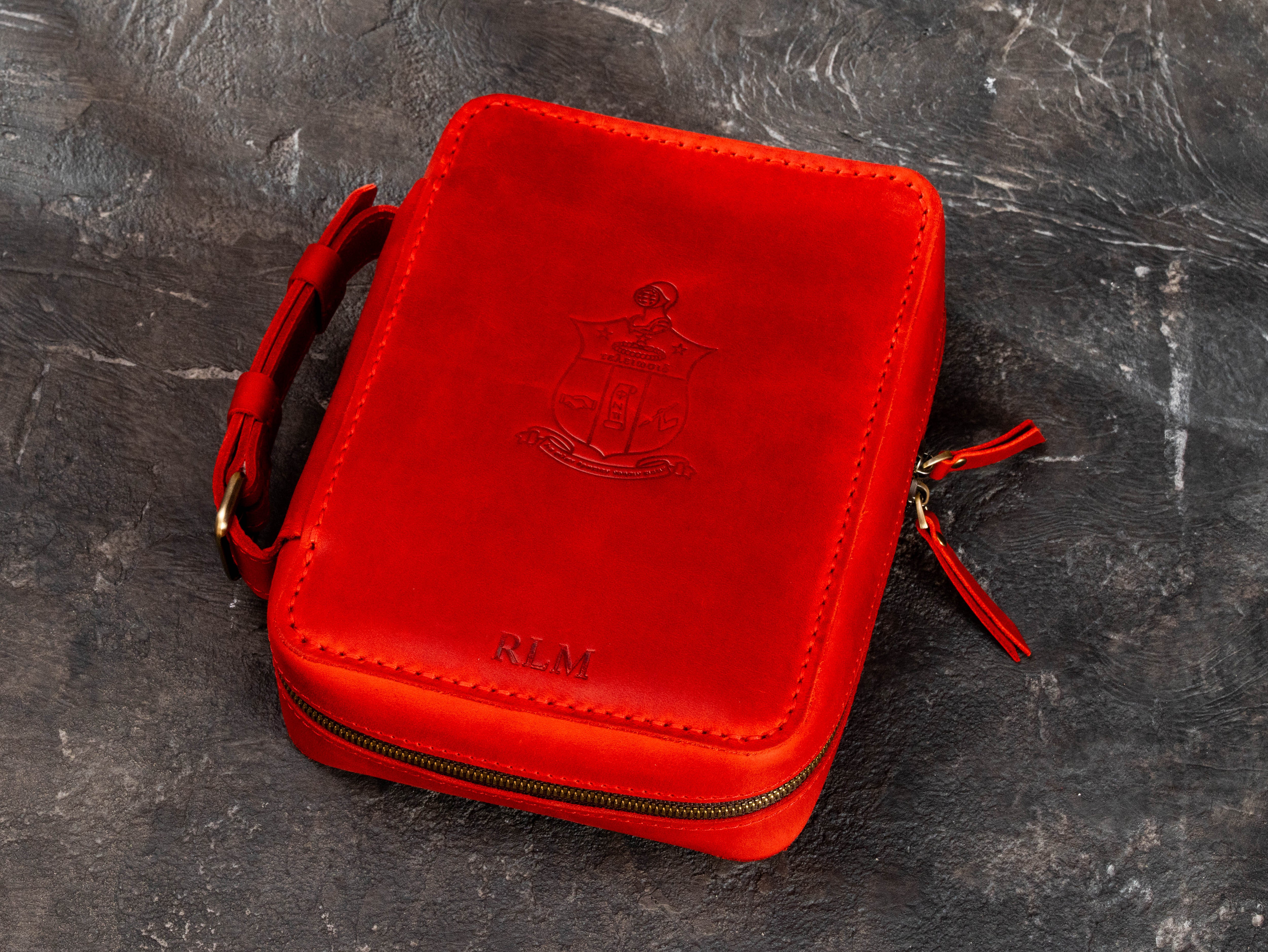 Personalized red leather cigar case with custom client-supplied fraternity crest, RLM initials and upgraded dual zipper closure.