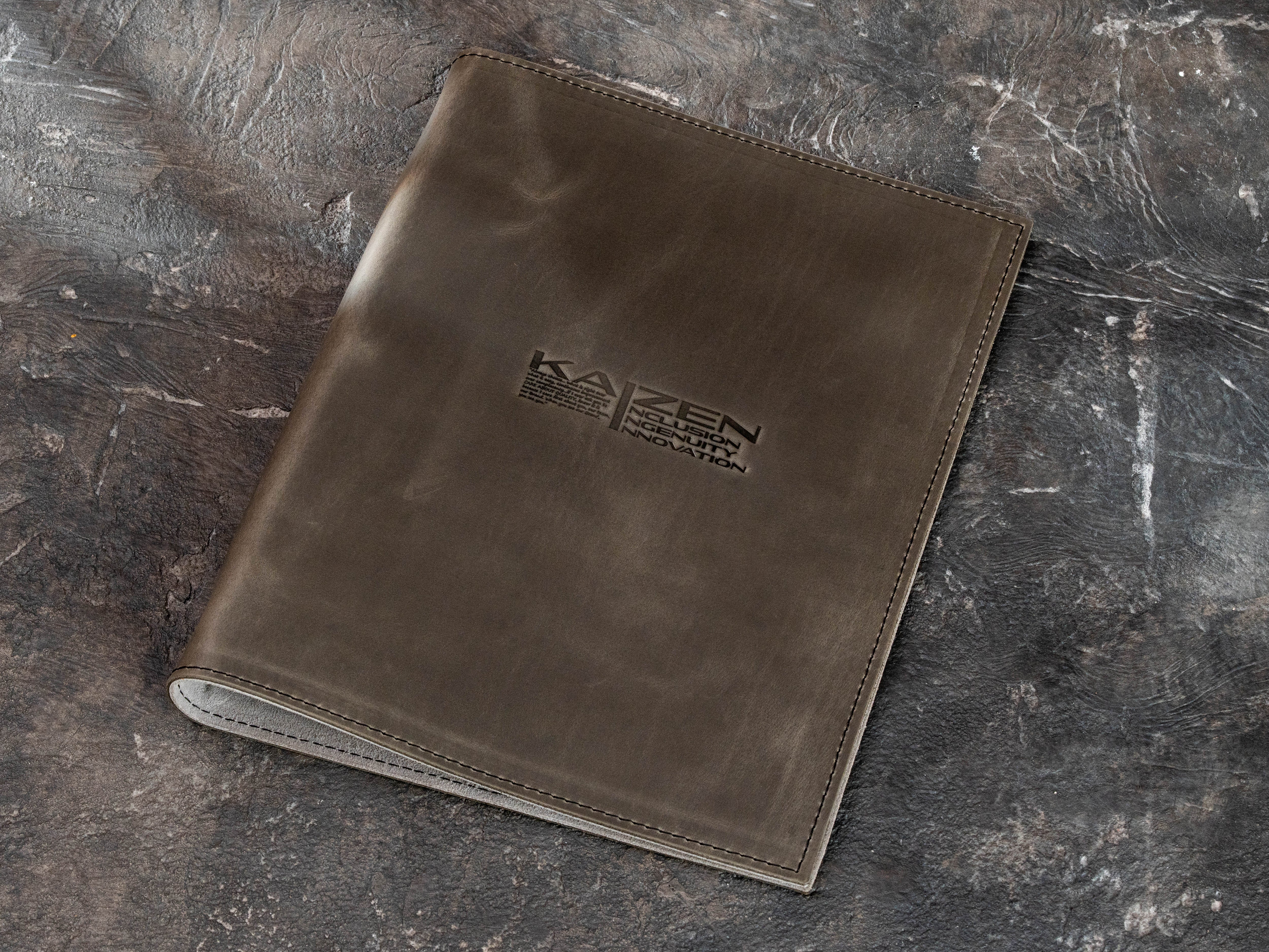 Custom Gray Crazy Horse leather corporate 3-ring binder with KAIZEN logo and machine-stitched cover.