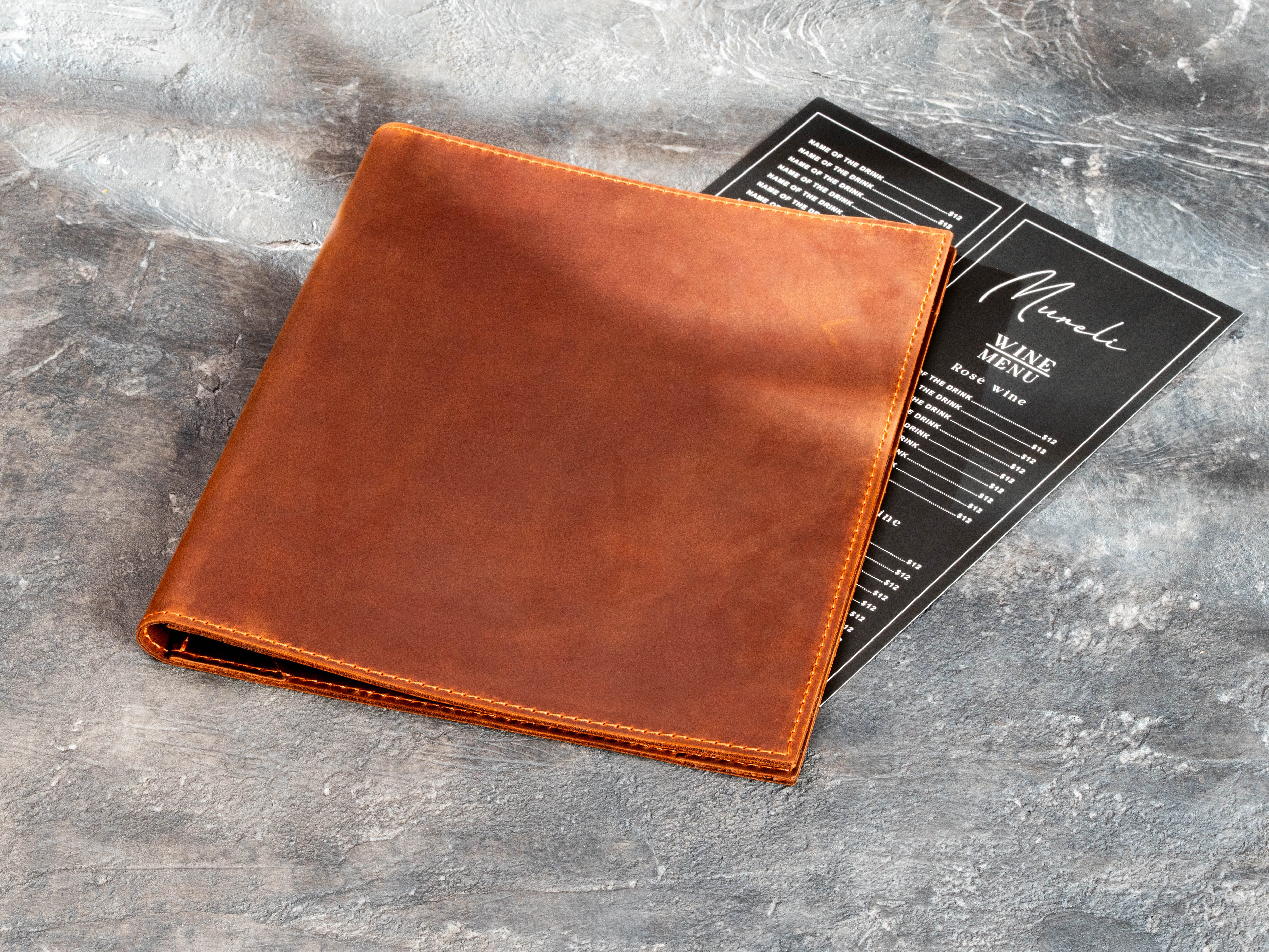 brown leather restaurant menu folder with soft double-layer construction and stitched edges.