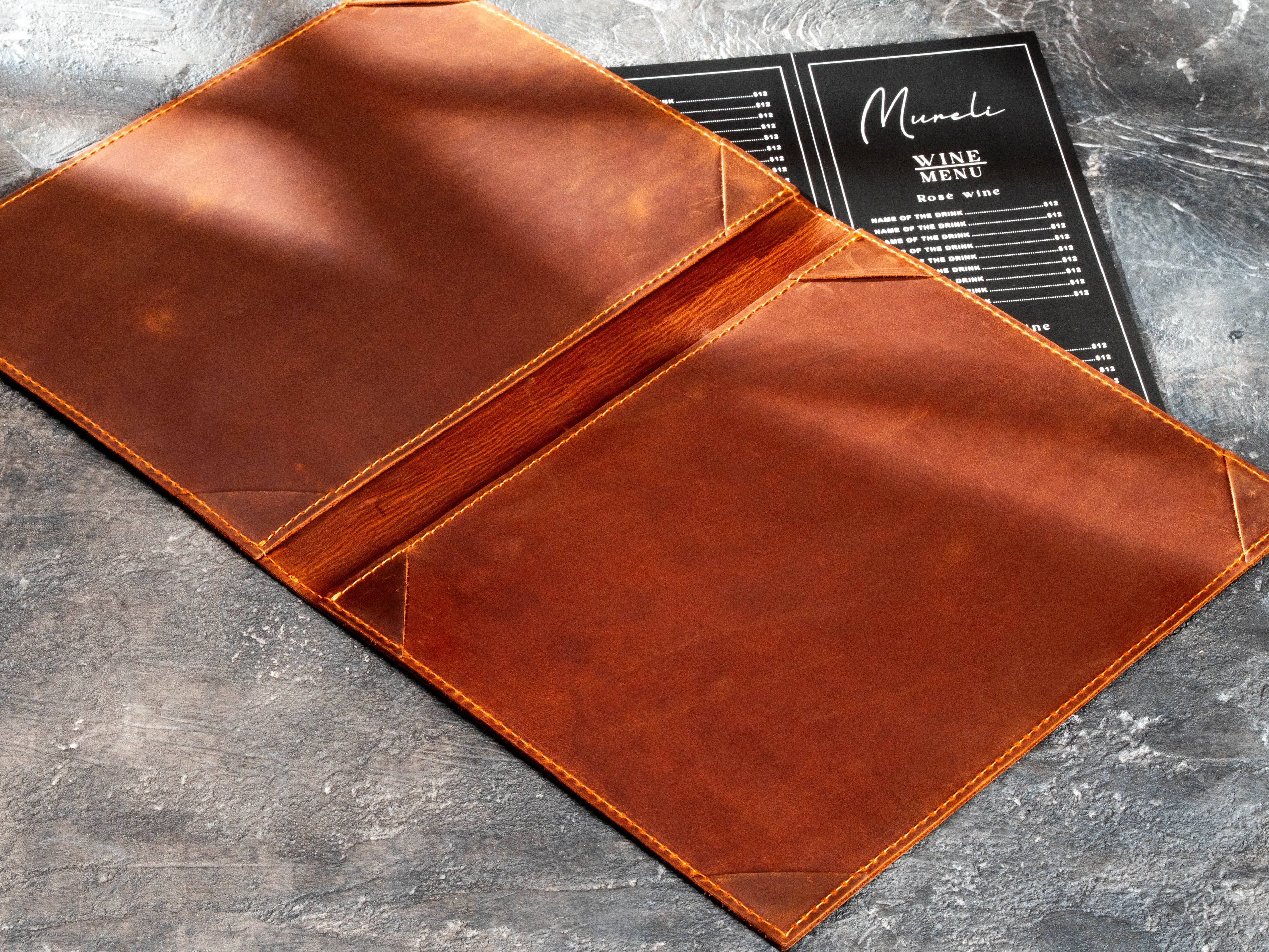 double-layer brown leather menu folder showing straight leather corner holders and stitched construction